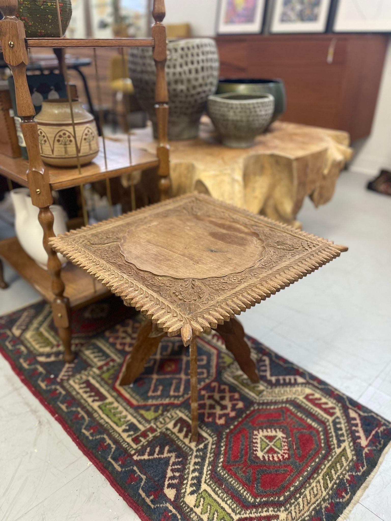 Intricate Carved Floral Motif on the Square top and Legs of this Beautiful Accent Table. The Edges have been Carved in to Leaf Pattern. X- Panel Base. Vintage Condition Consistent with Age as Pictured.

Dimensions. 18 W ; 18 D ; 16 H