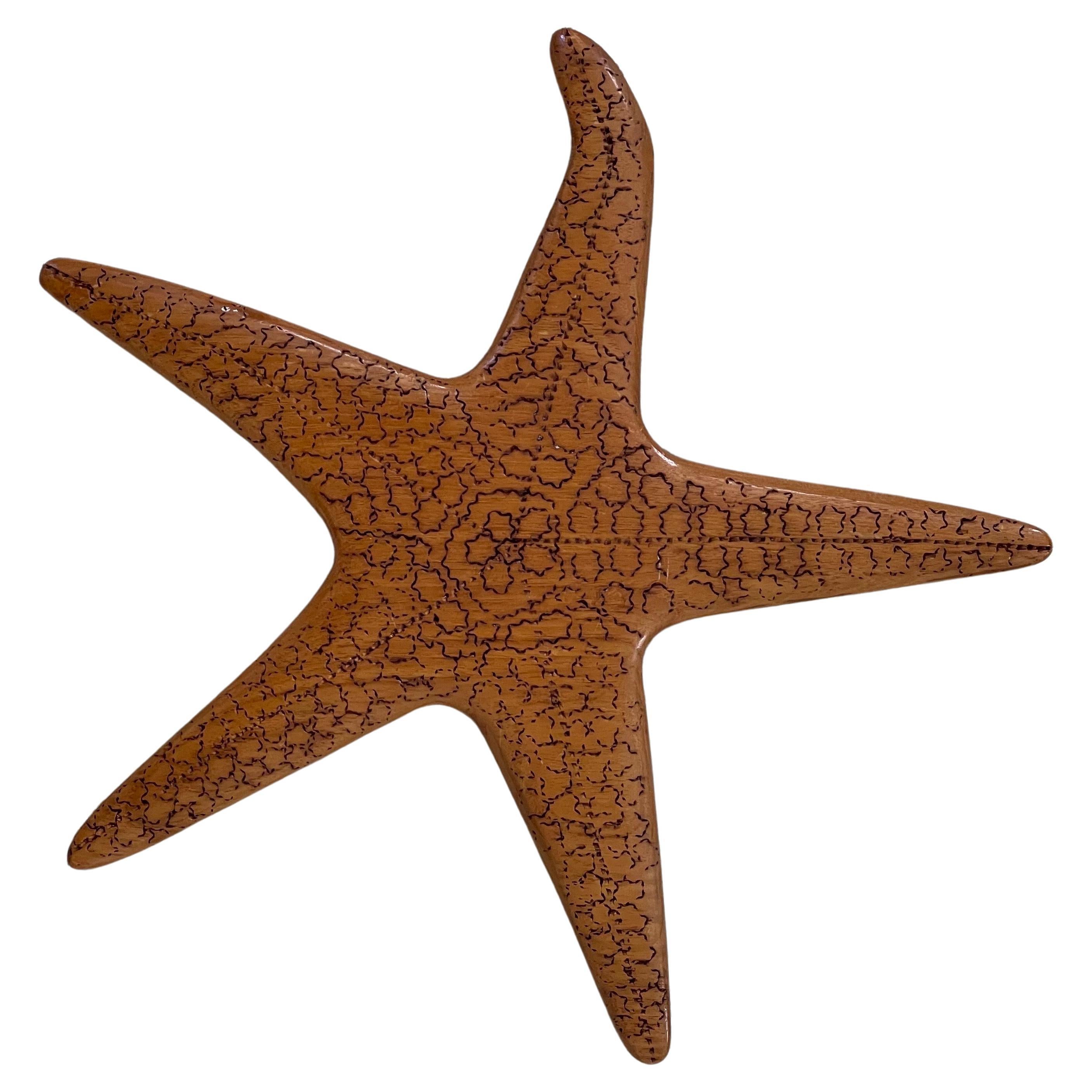 A fun vintage carved wood starfish wall hanging sculpture, circa 1970s. This piece is in very good vintage condition and measures 14.5