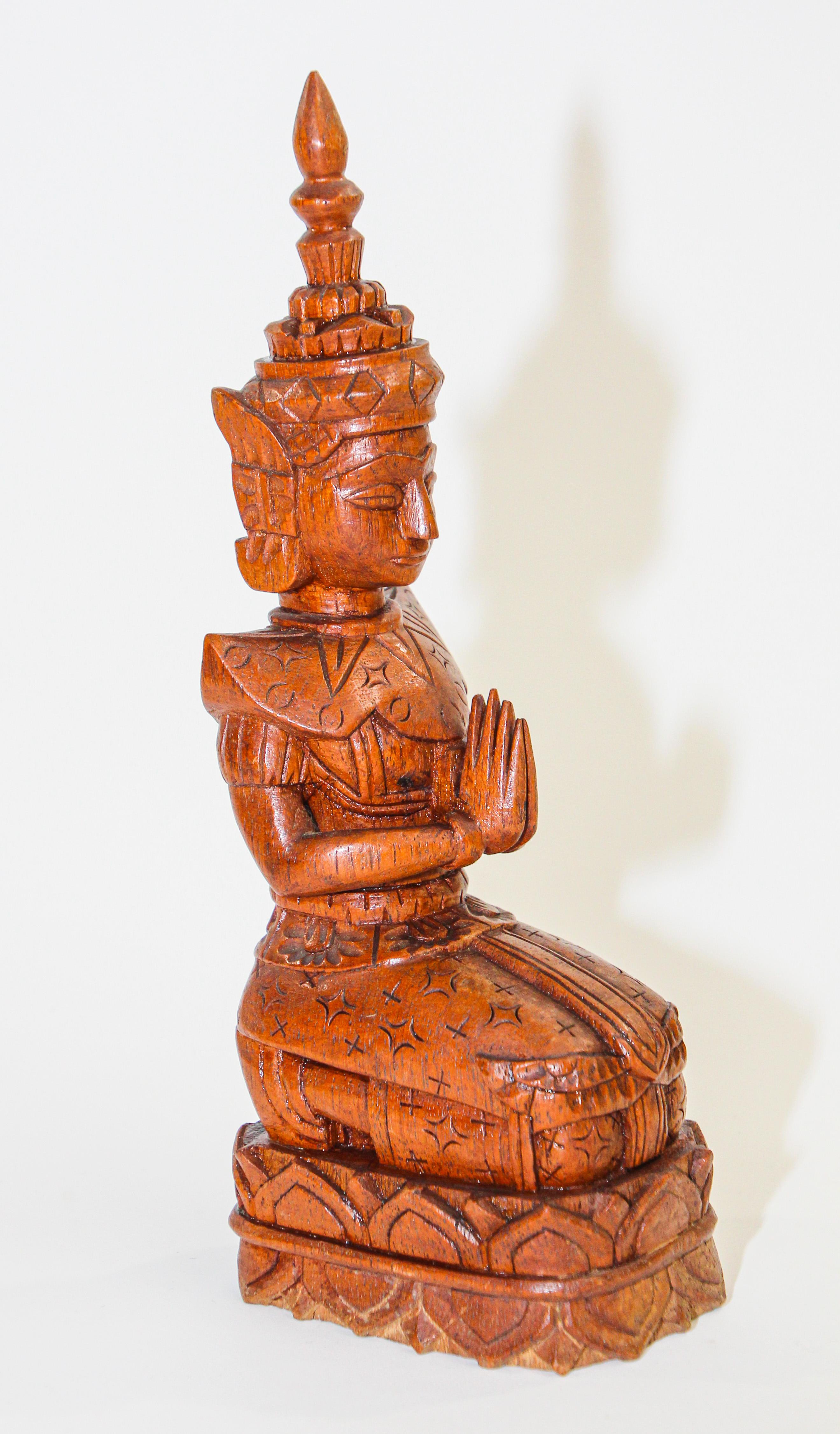 Vintage Wood Carving Art Thai Buddha Figure kneeling and praying.
Vintage Mid century wood carving art of a peaceful Thai female figure kneeling and praying. 
Beautifully detailed figurine reproduction of a classic Thai style Thepanom, an Aparasa