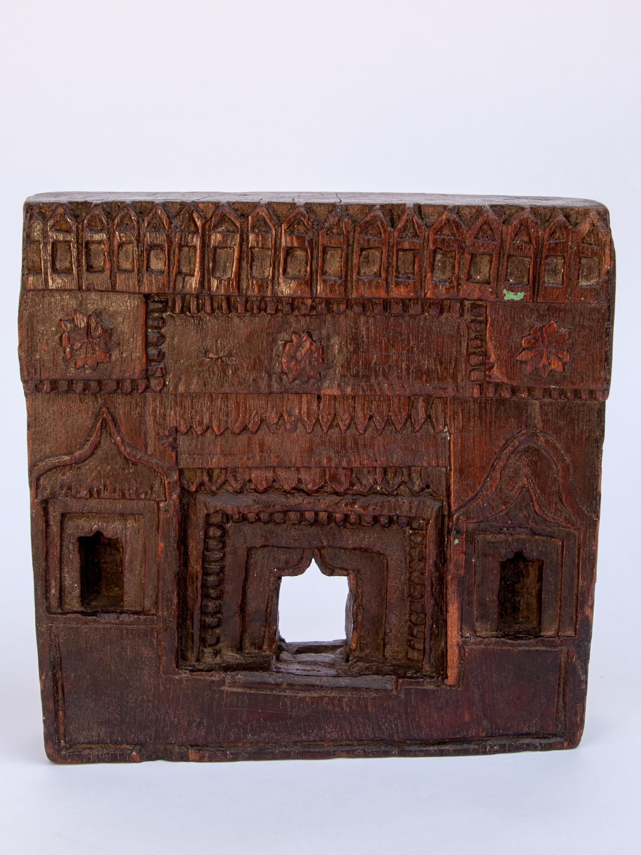 Vintage miniature architectural votive or picture frame. Mid-20th century, India. Wooden, hand carved, mid-20th century. Measures approx: 9.5 wide x 9.5 high. 
This vintage hand carved wooden frame, from South India, is basically a rustic