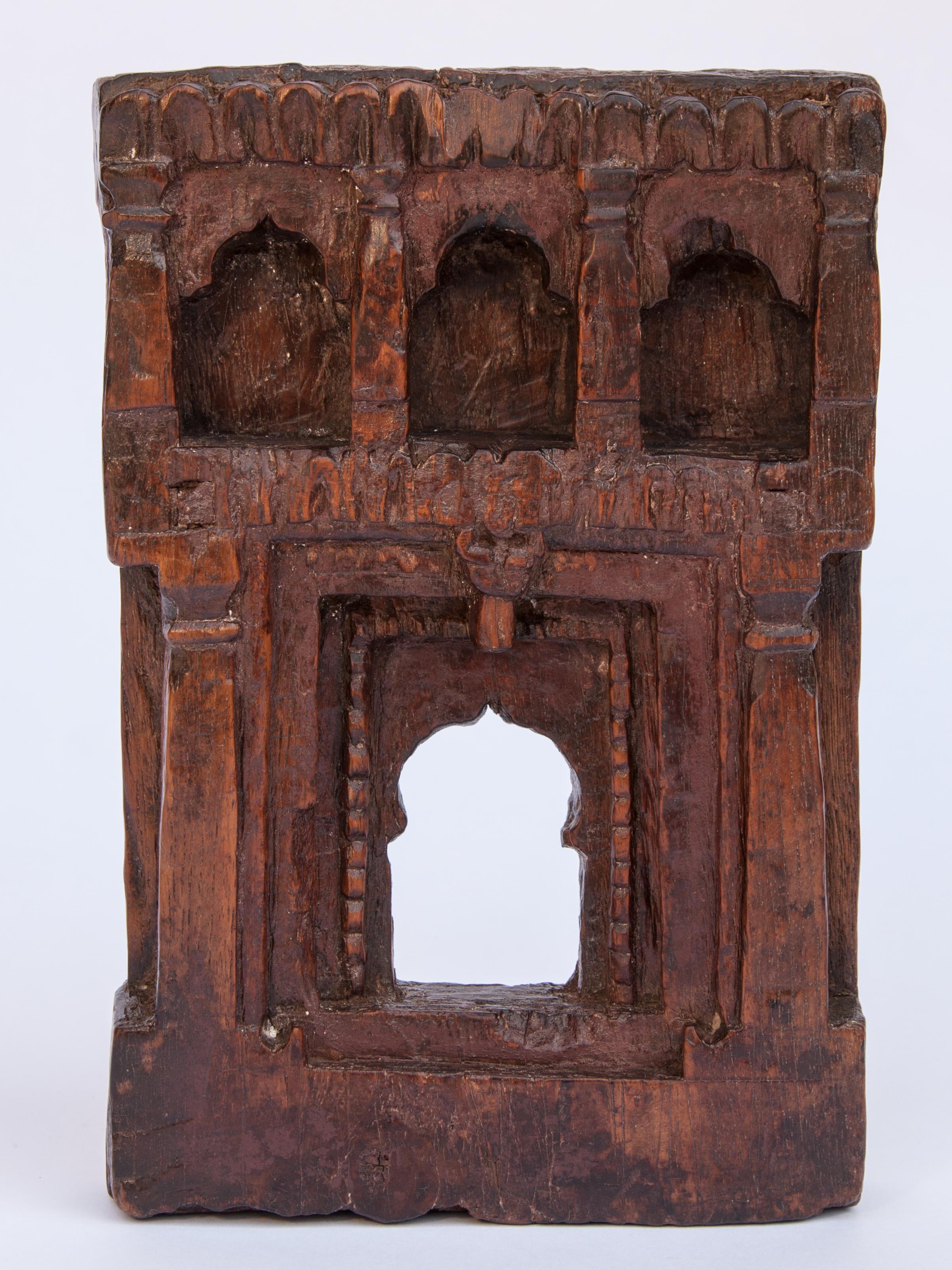 Vintage miniature architectural votive or picture frame. Mid-20th century, India. Wooden, hand carved, mid-20th century. Measures approx: 6 inches wide x 9.5 inches high. 
This vintage hand carved wooden frame, from South India, is basically a