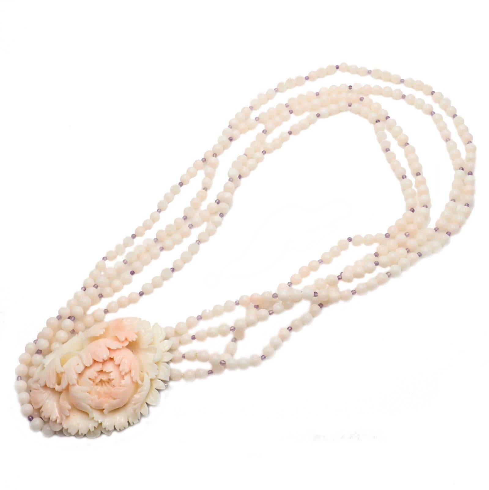 18k White Gold Carved Angel Skin Coral Amethyst Gold Necklace by Carvin French. 
With Round Angel Skin Coral Beads: 5mm
Hand Carved Angel Skin Coral Pendant: 42mm x 57mm
Amethyst Beads: 1mm
Details: 
Length: 18