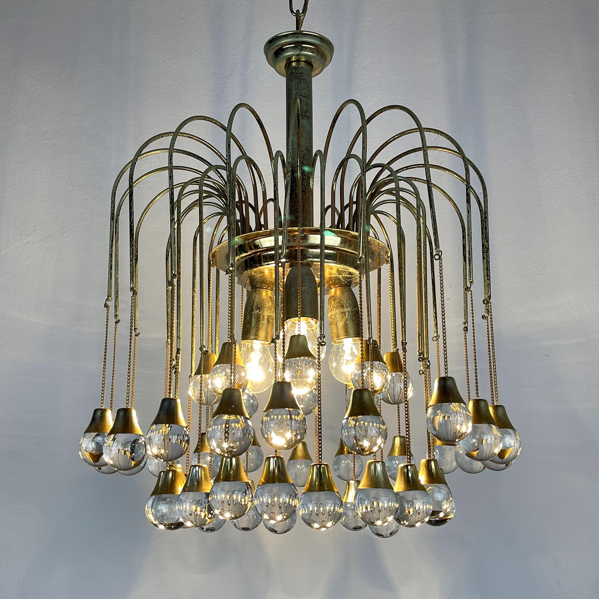 The incredibly beautiful chandelier made in Italy in the 1960s. The base is made of brass, which has acquired a natural patina over time. 48 glass balls. Very good vintage condition. There are minimal signs of wear. The metal has a beautiful natural