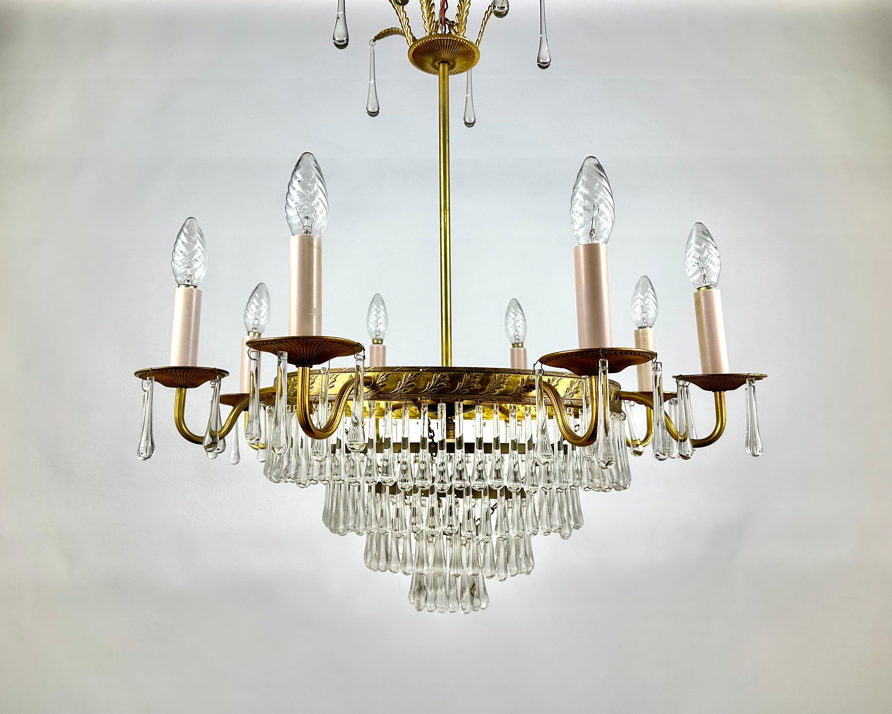 Luxurious Cascading Crystal And Brass Chandelier from France 1960s.

Crystal and brass chandelier is the quality in every detail of the lighting fixture.

Brass frame of gold color and crystal transparent details perfectly complement the interior of