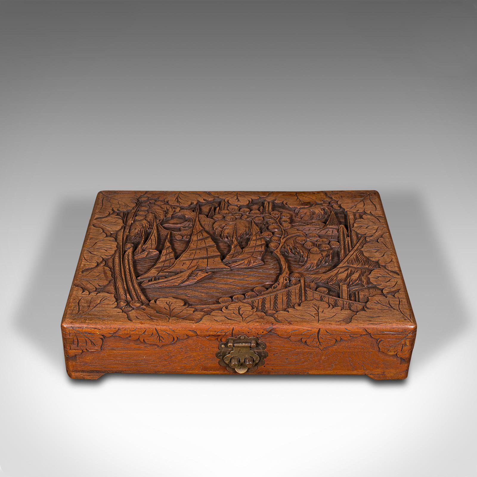 This is a vintage cased Mah Jong set. A Chinese, carved teak gaming box, dating to the late 20th century, circa 1970.

Strikingly decorative box with 144-piece game inside
Displays a desirable aged patina throughout
Teak case enthusiastically
