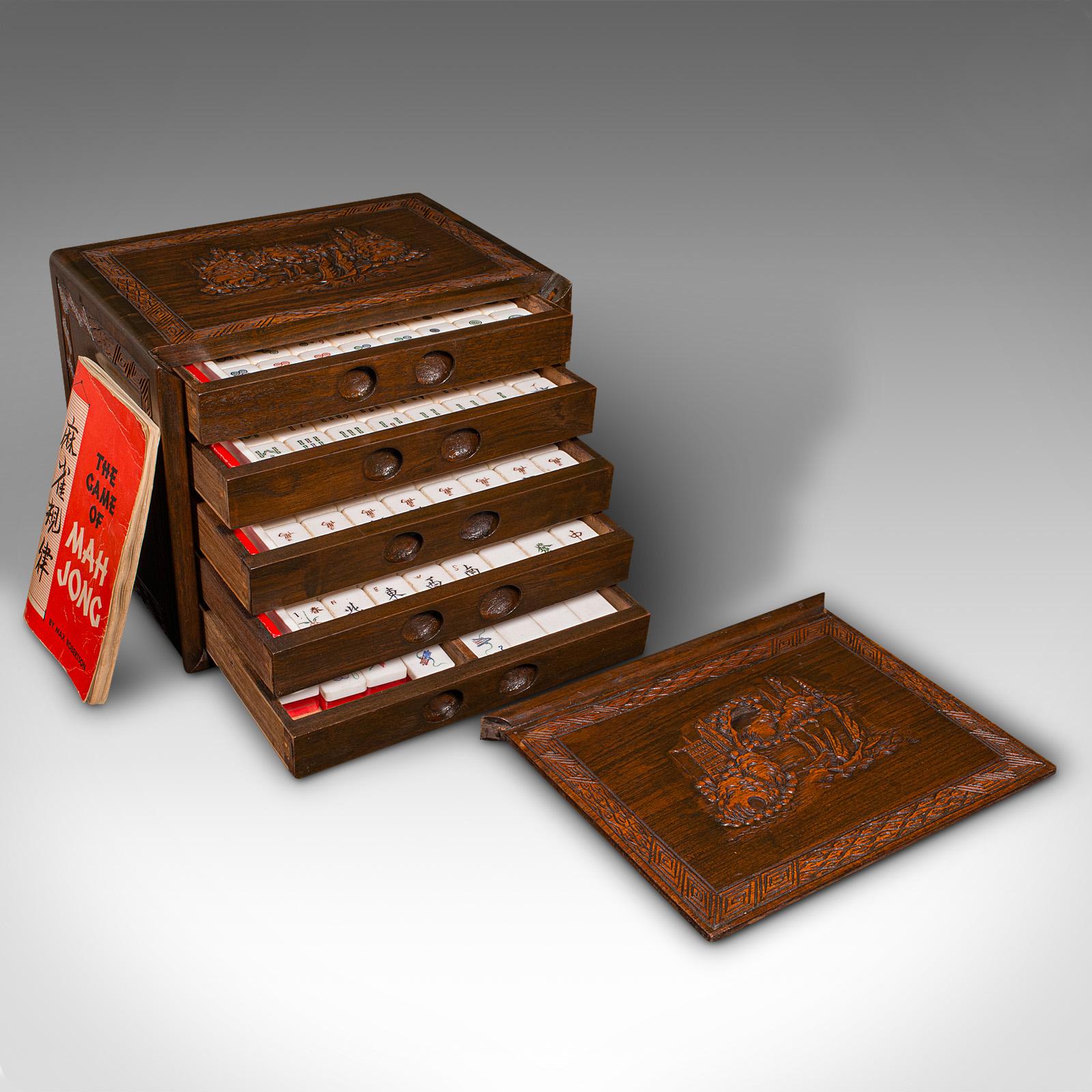 
This is a vintage cased mahjong set. A Chinese, carved teak gaming set, dating to the mid 20th century, circa 1950.

Beautifully presented set in a quality case
Appealing 144-piece vintage set with instruction book
Displays a desirable aged patina
