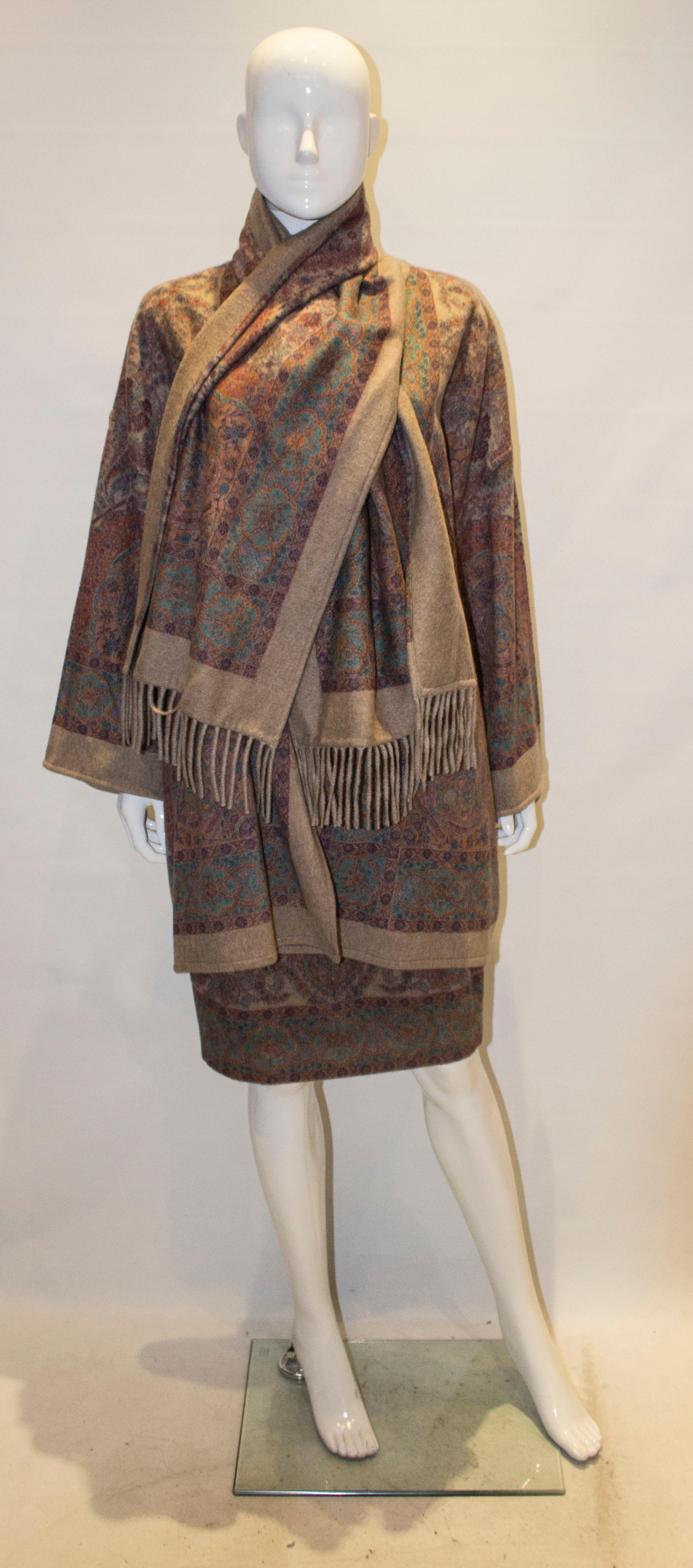 A chic vintage cashmere jacket with attached scarf, The jacket is in a biscuit colour cashmere with a one popper fastening. 
Measurements bust up to 42'', length 37''