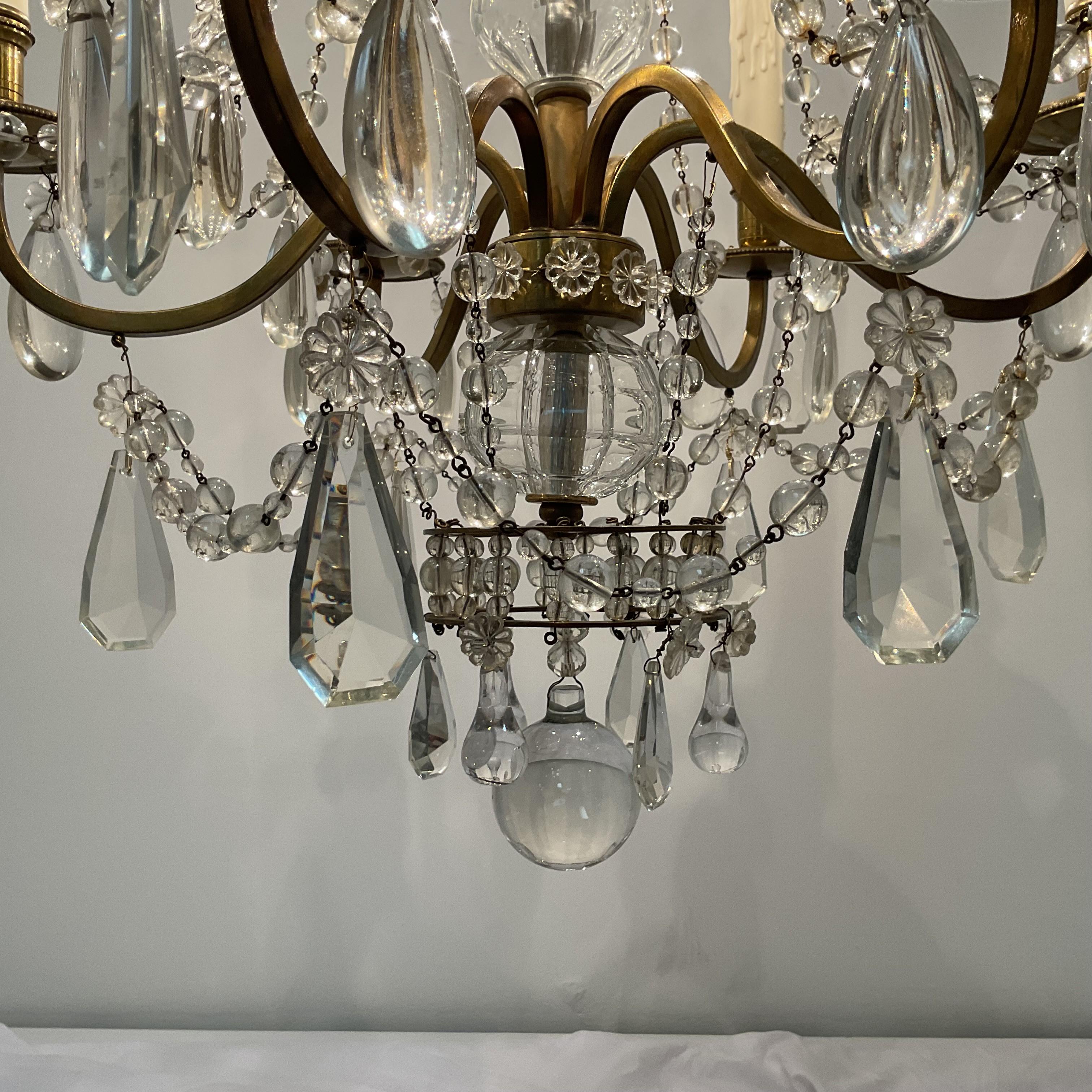 Gorgeous lead hand-cut crystal pendants and beads on a suspended Brass Frame. Amazing, unusual design and form. Completely rewired with American standard candleabra sockets and wires. Polycarbonate drip candle covers. Comes ready to install with 3ft