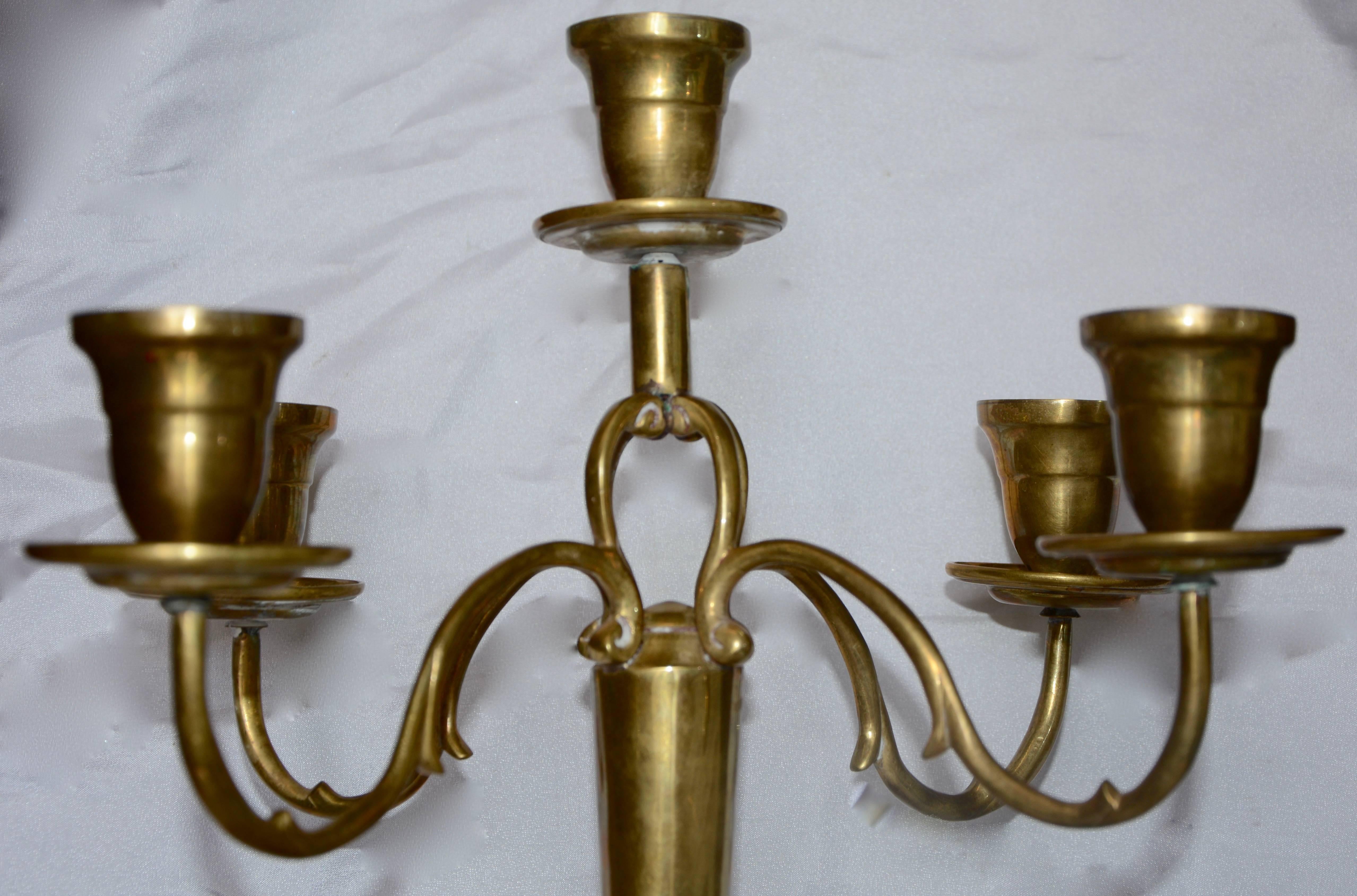 Swirls abound in this cast brass candelabra from India. The substantial base boasts a swirled border and the four arms swirl outward to hold the cups. The centre cup rests atop four scrolled arms. The inside of the cups measure 7/8