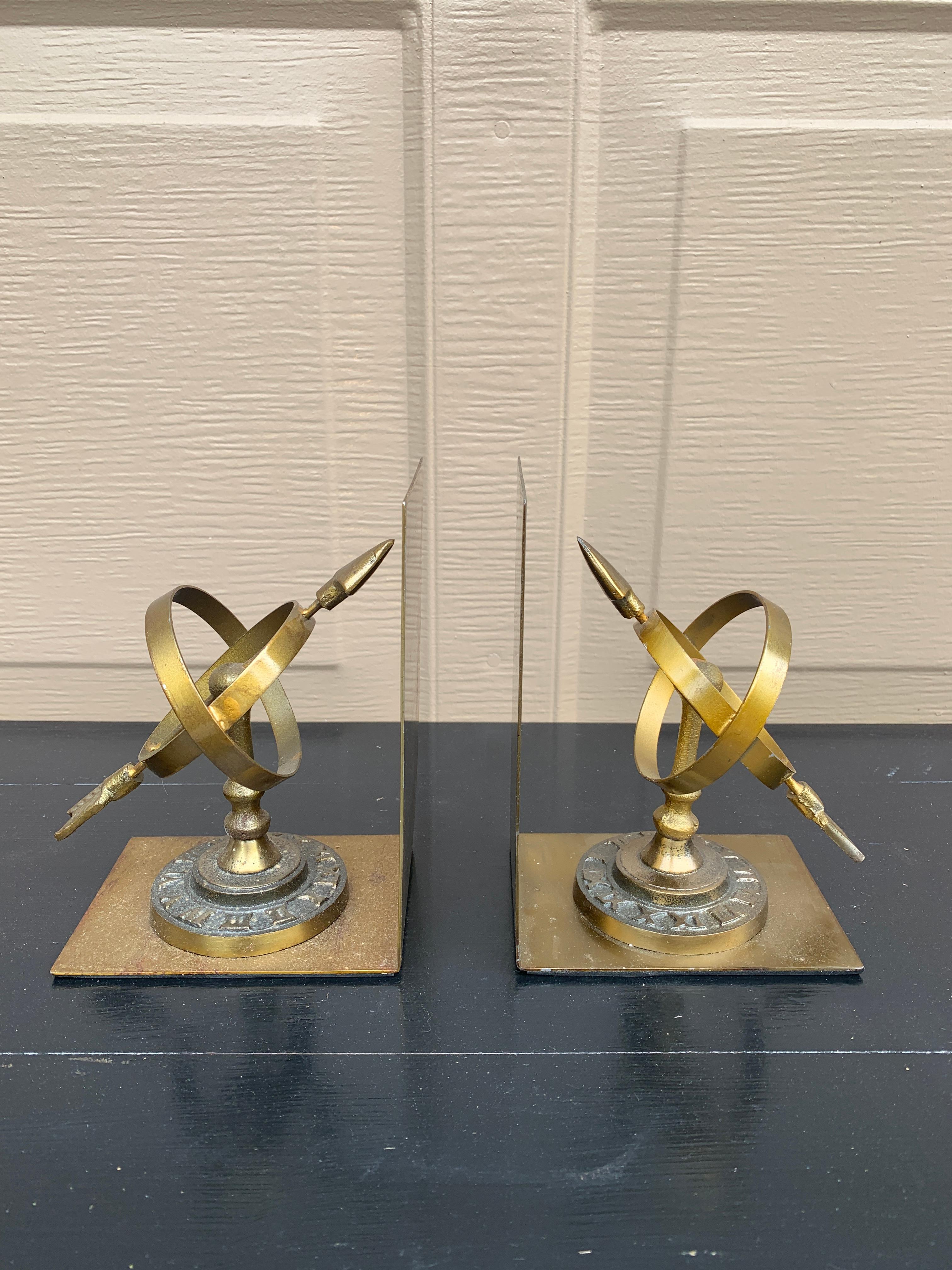 A beautiful pair of cast brass bookends in the form of two neoclassical celestial armillary sundials with roman numerals

Circa 1980s

Measures: 4.5