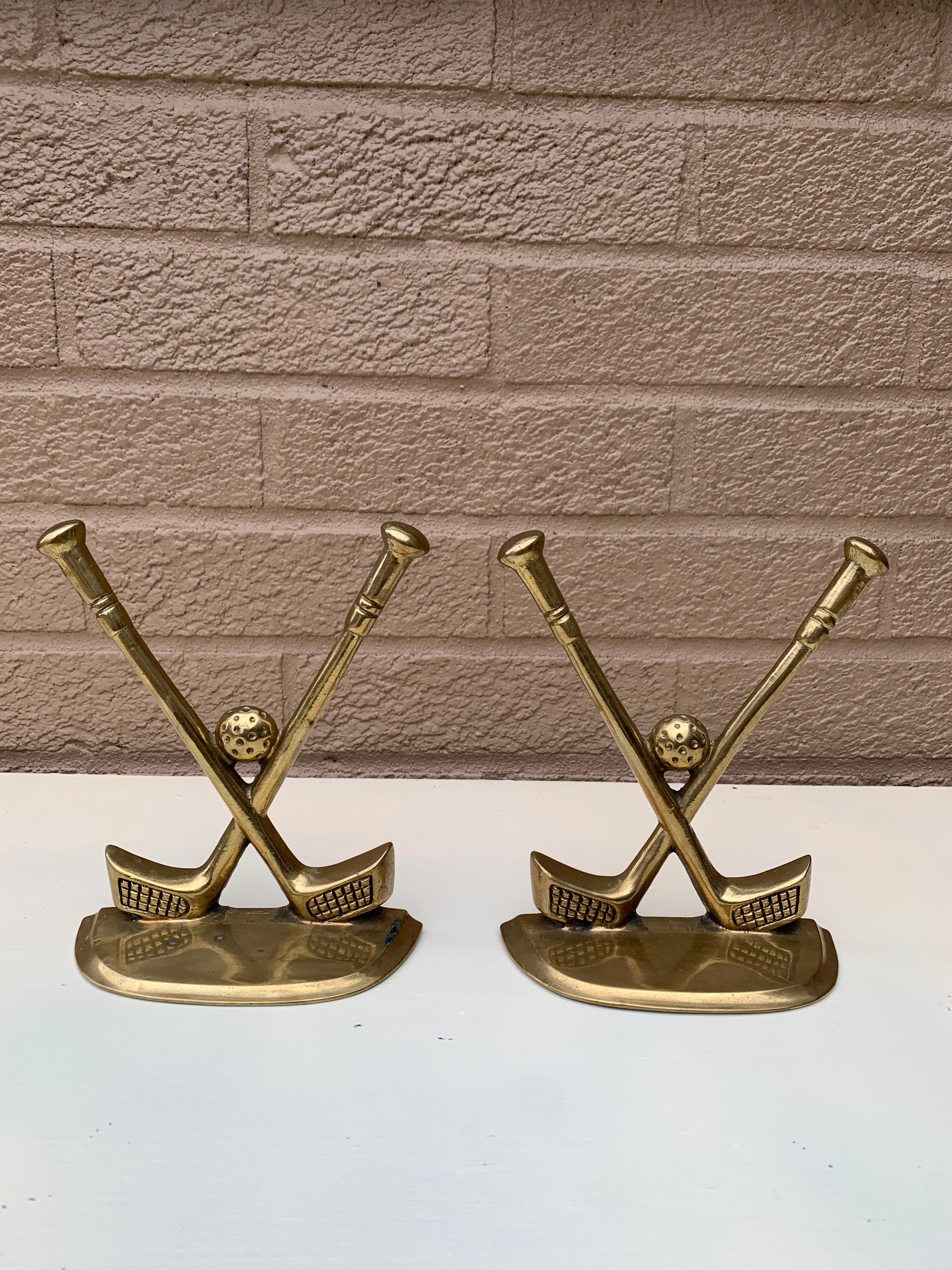 A beautiful pair of cast brass bookends in the form of two golf clubs and golf balls.

Circa 1980s

Measures: 4.88