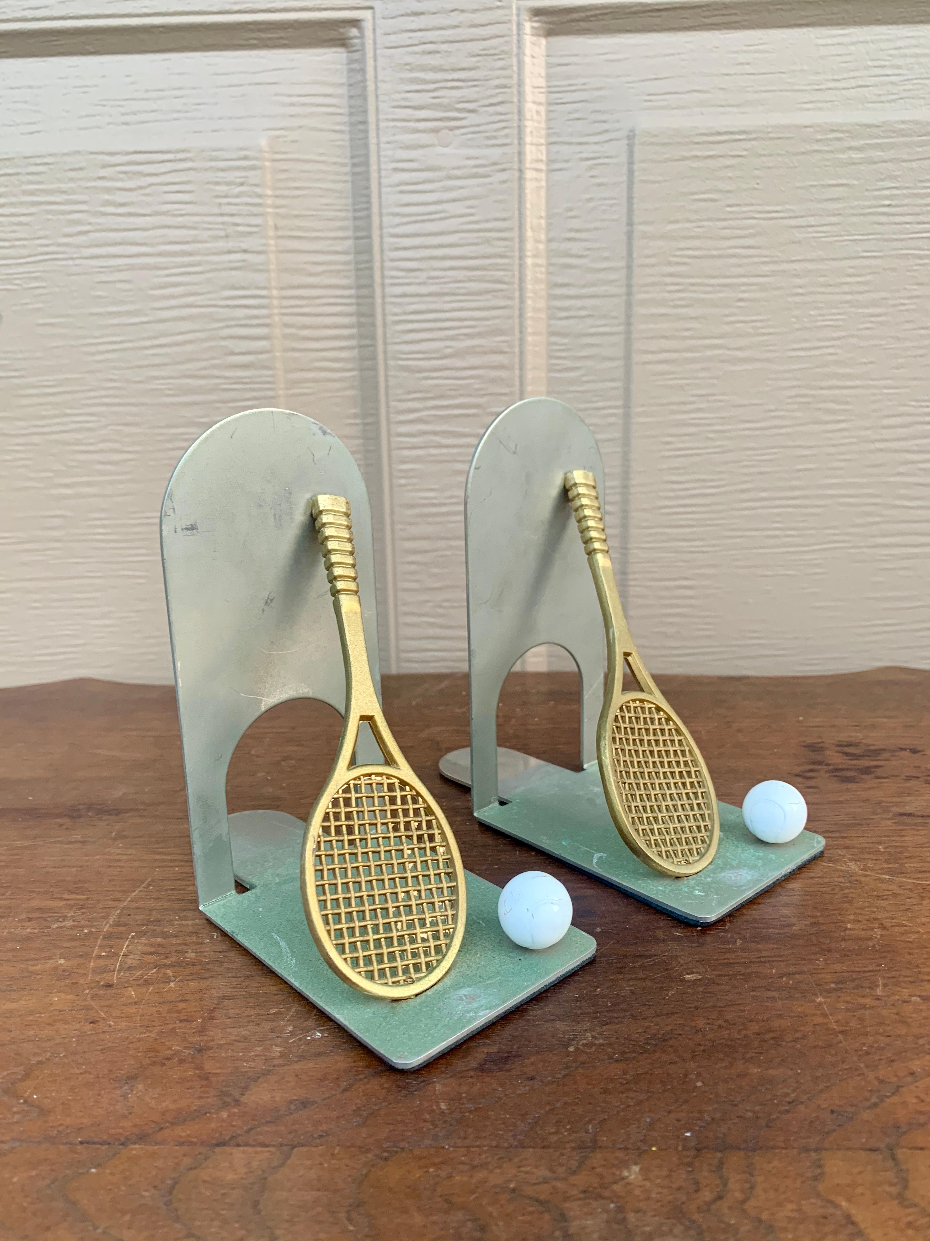 A beautiful pair of cast brass bookends in the form of two tennis rackets and tennis balls.

USA, Circa 1980s

Measures: 5.5