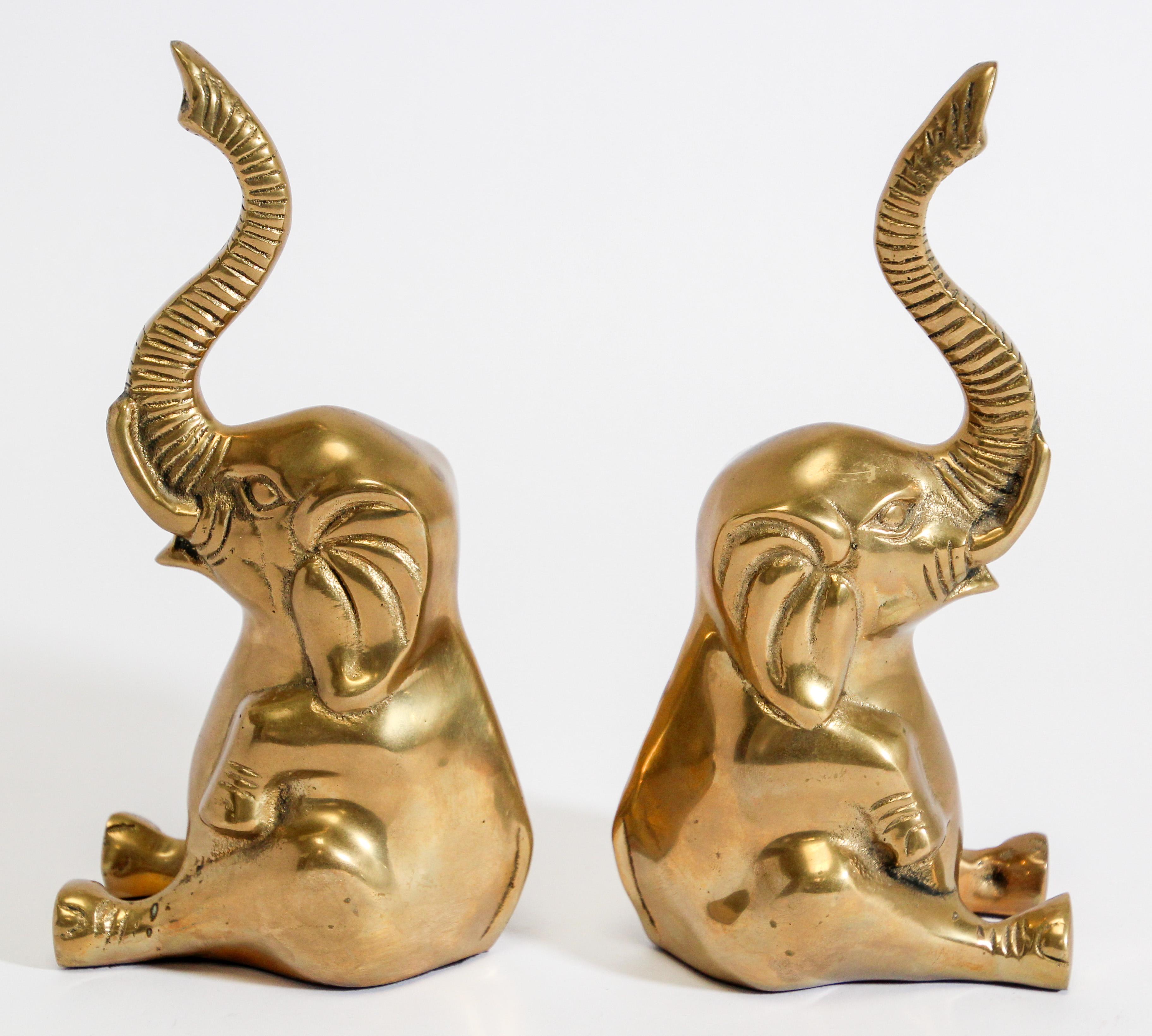 Vintage cast polished solid brass elephant sculpture paper weight or book ends.
The elephants are seated and their trunk is up for good luck. 
Lots of detail on the front and sides of the elephant.
Dimensions: 4