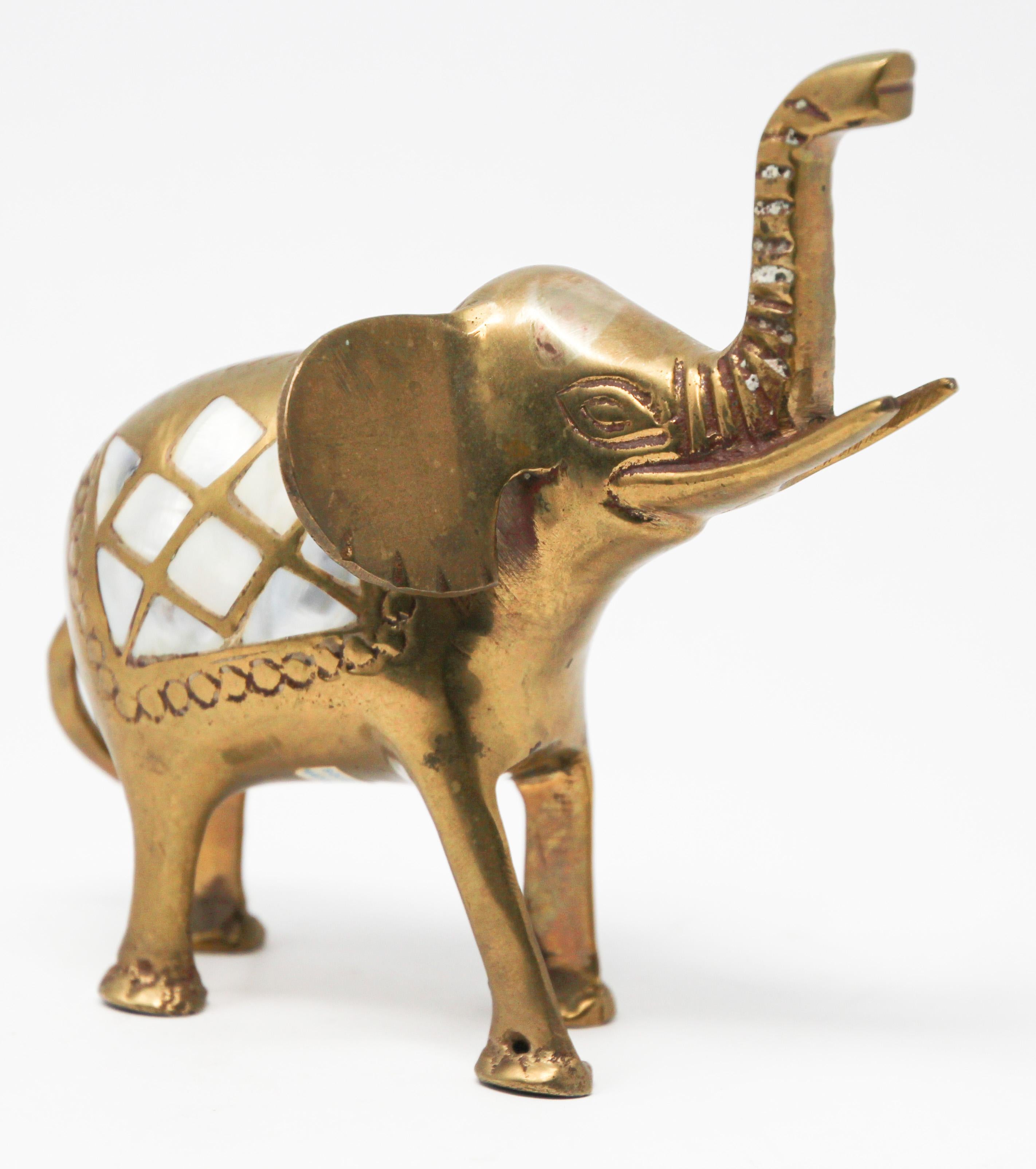 Vintage cast solid polished brass elephant sculpture paper weight.
The elephant has mother of pearl inlaid and his trunk is up for good luck.
Nice decorative shelf or desk accessories
Dimensions: 6.5