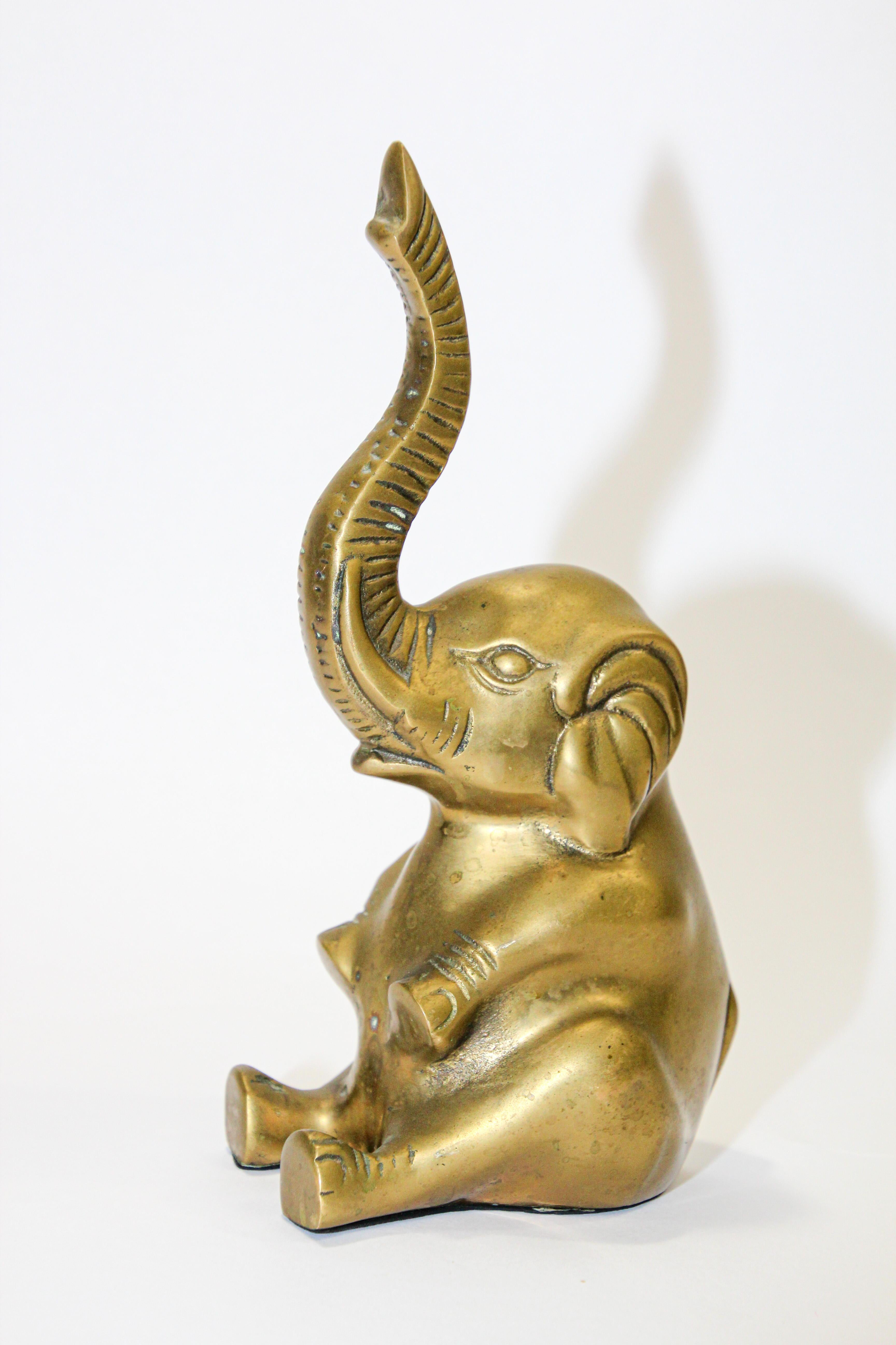 Vintage cast solid polished brass elephant sculpture paper weight.
The elephant is seated and a trunk is up for good luck.
Dimensions: 4.5
