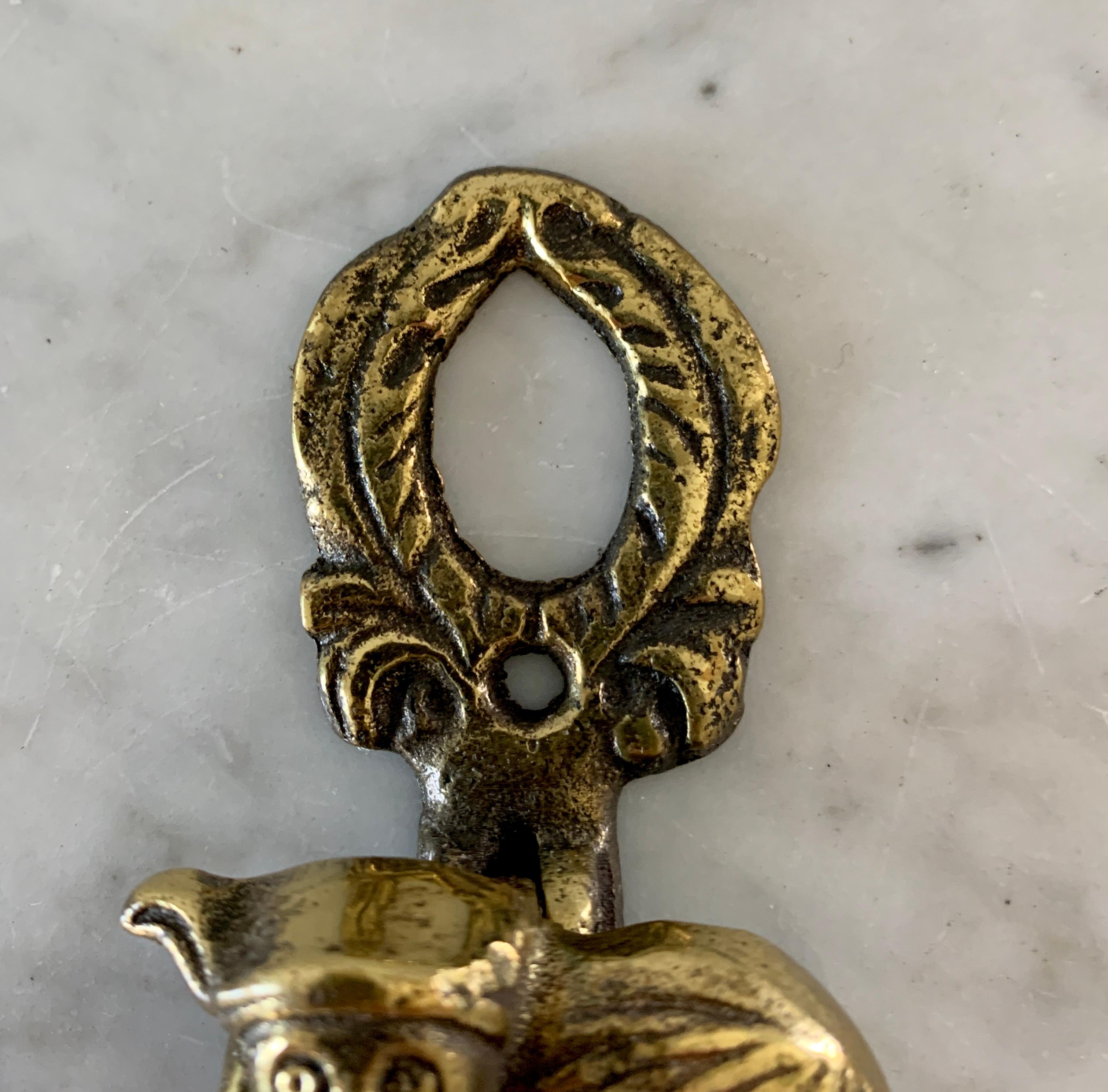 A wonderful solid cast brass door-knocker fashioned as a horned imp or devil. The design is based on one found at the 1000 year old Chester Cathedral in England where the imp in question was said to wrought his havoc. 

Restoration teams