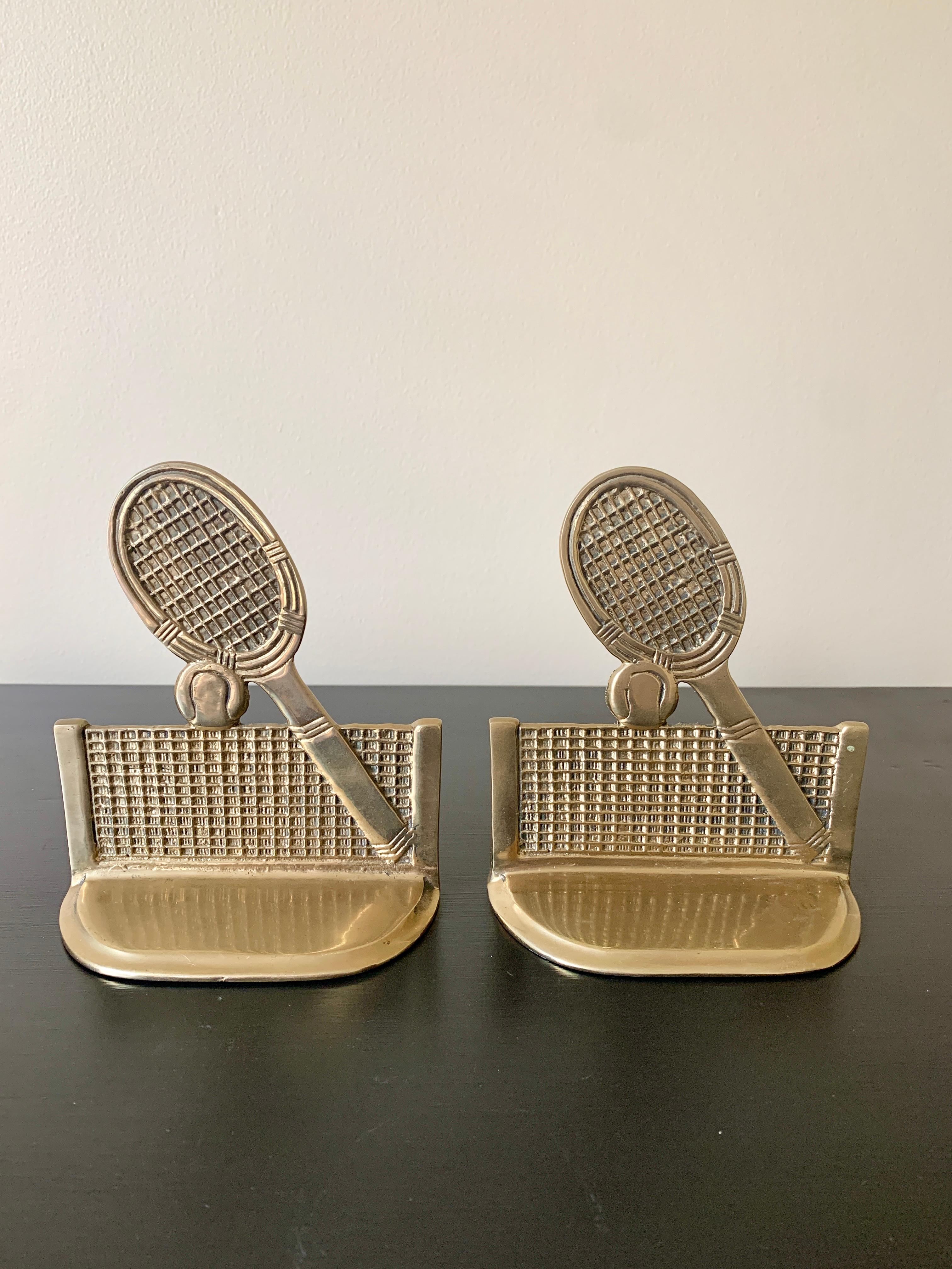 A beautiful pair of cast brass bookends in the form of tennis rackets, nets, and tennis balls.

USA, Mid-20th Century

Measures: 5.13