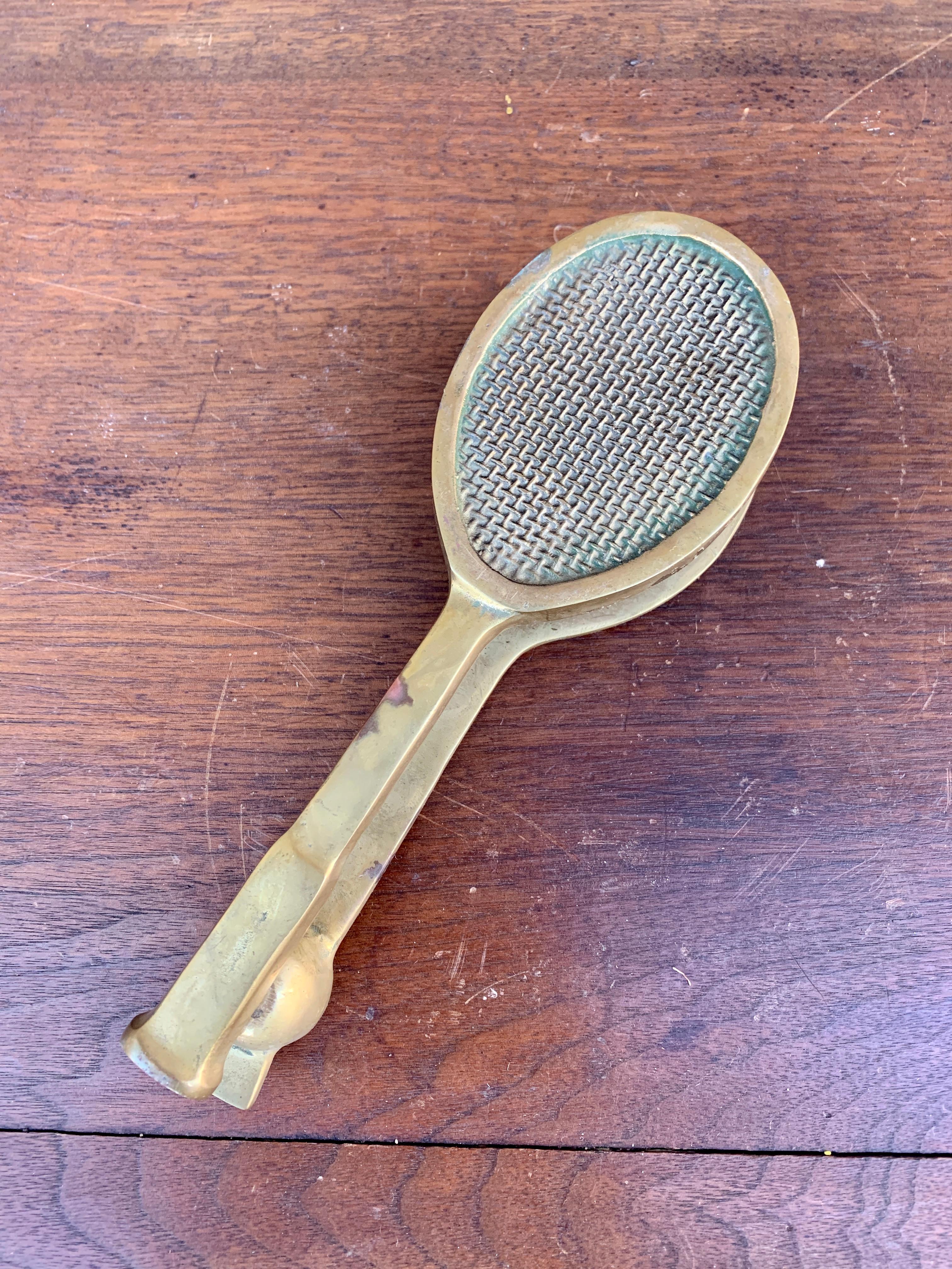 A beautiful cast brass door knocker in the form of a tennis racket.

USA, Late-20th Century

Measures: 2.75