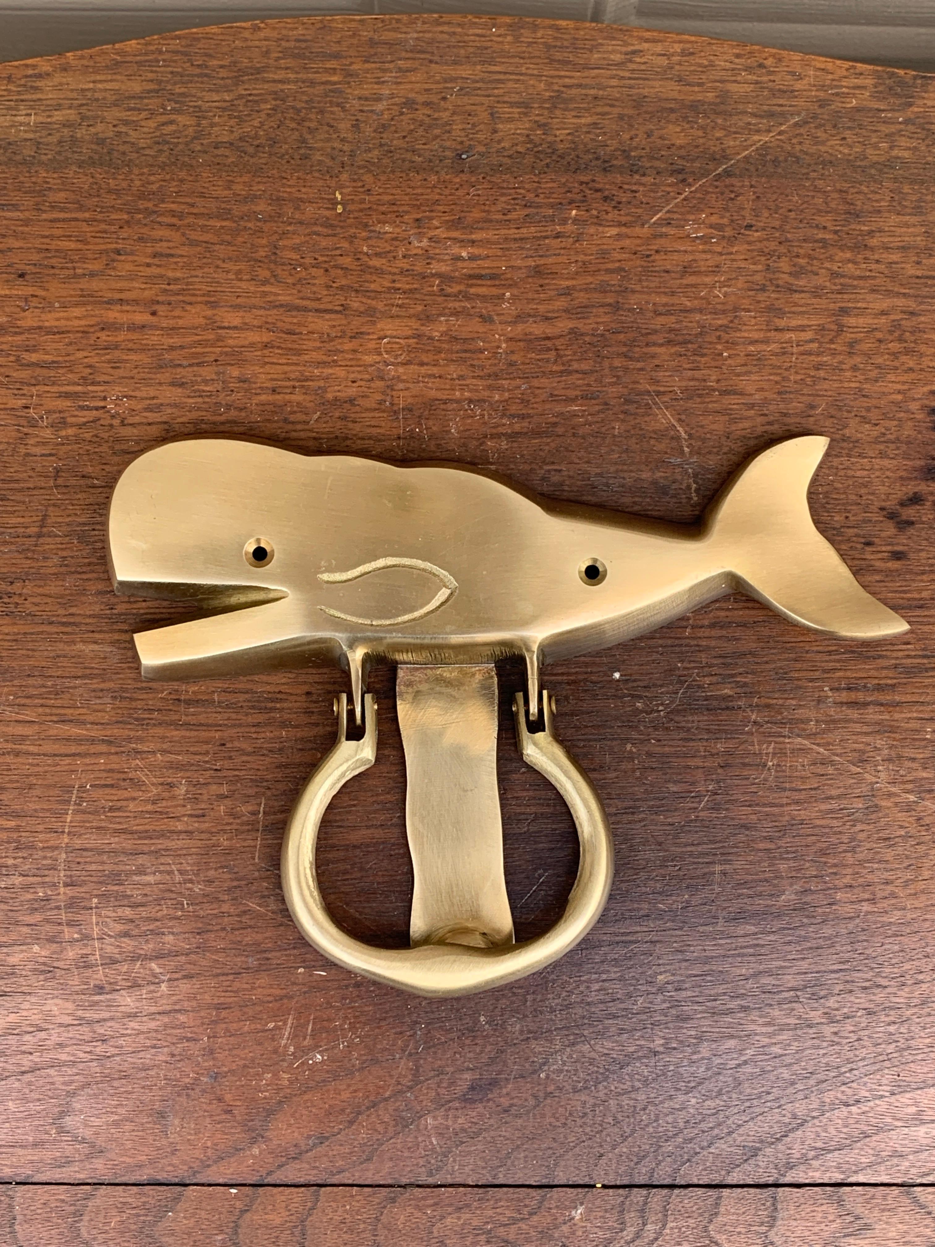A gorgeous cast brass whale door knocker, perfect for your Nantucket, Cape, or Hamptons home!

USA, Mid-20th Century

Measures: 8.25