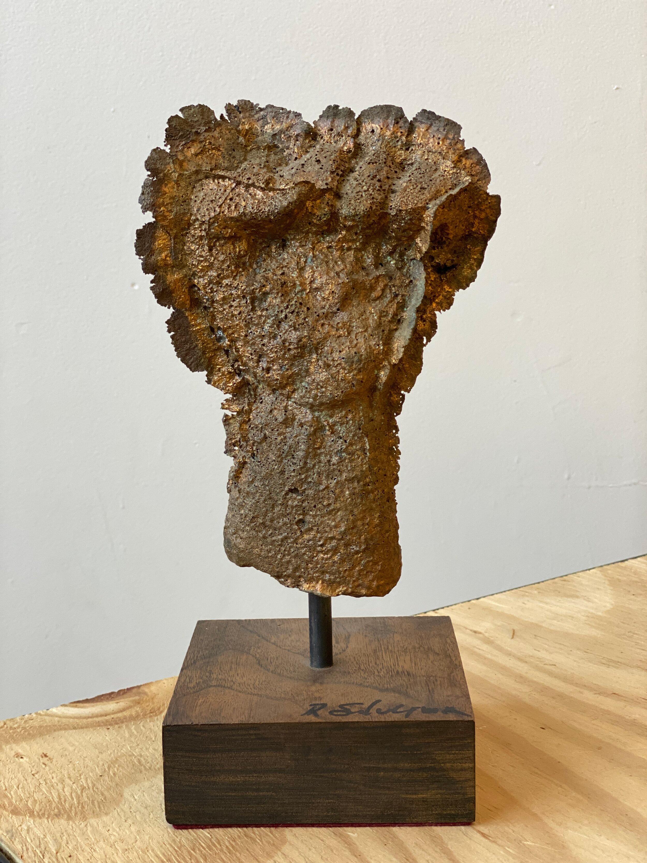 Vintage cast bronze fist sculpture on wood base, Signed R Silverman, circa 1980s. Rough cast bronze in the form of a closed fist. Often seen as the symbol of political solidarity, a raised fist is used as a salute to express unity, strength, or