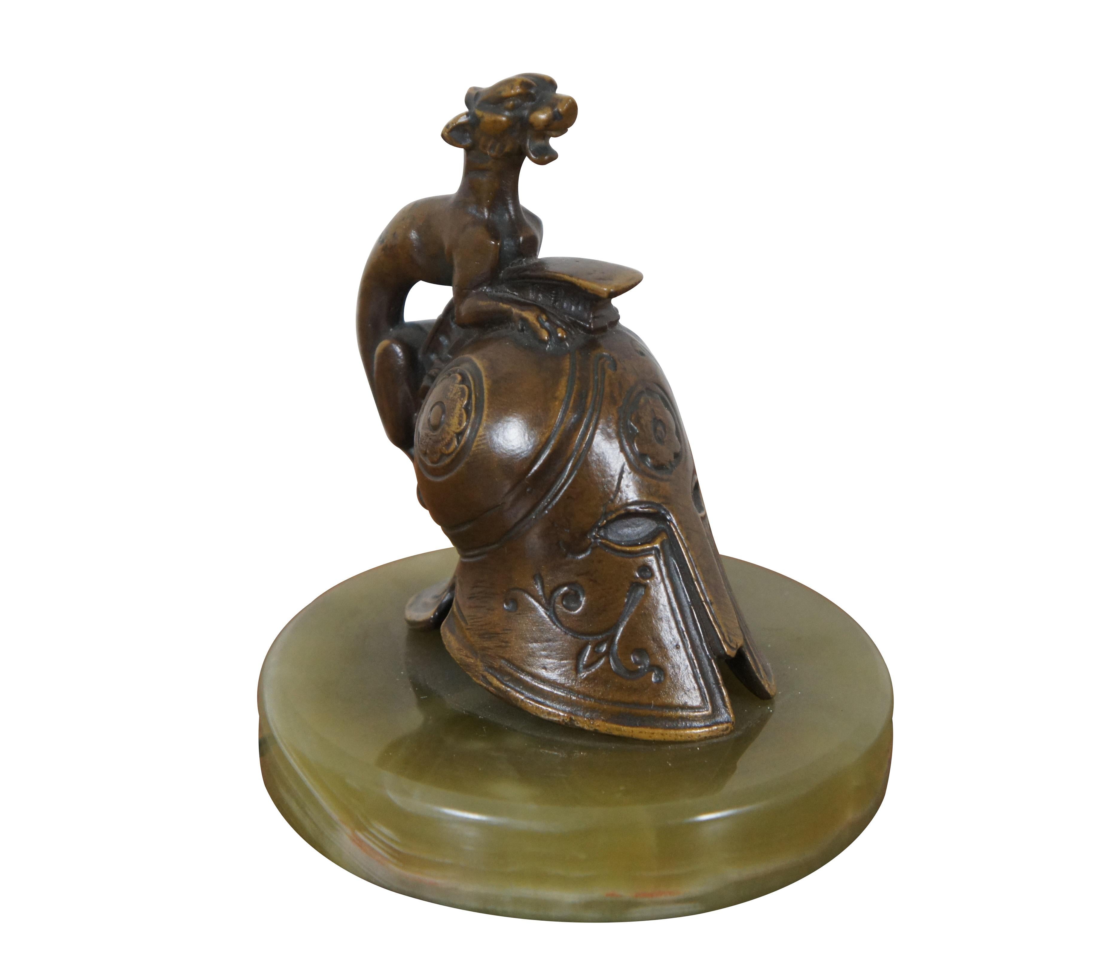 Vintage paperweight or book end featuring a bronze metal Greek / Corinthian / Spartan helmet adorned with a snarling animal, set on a translucent green stone / marble base.

Dimensions:
4