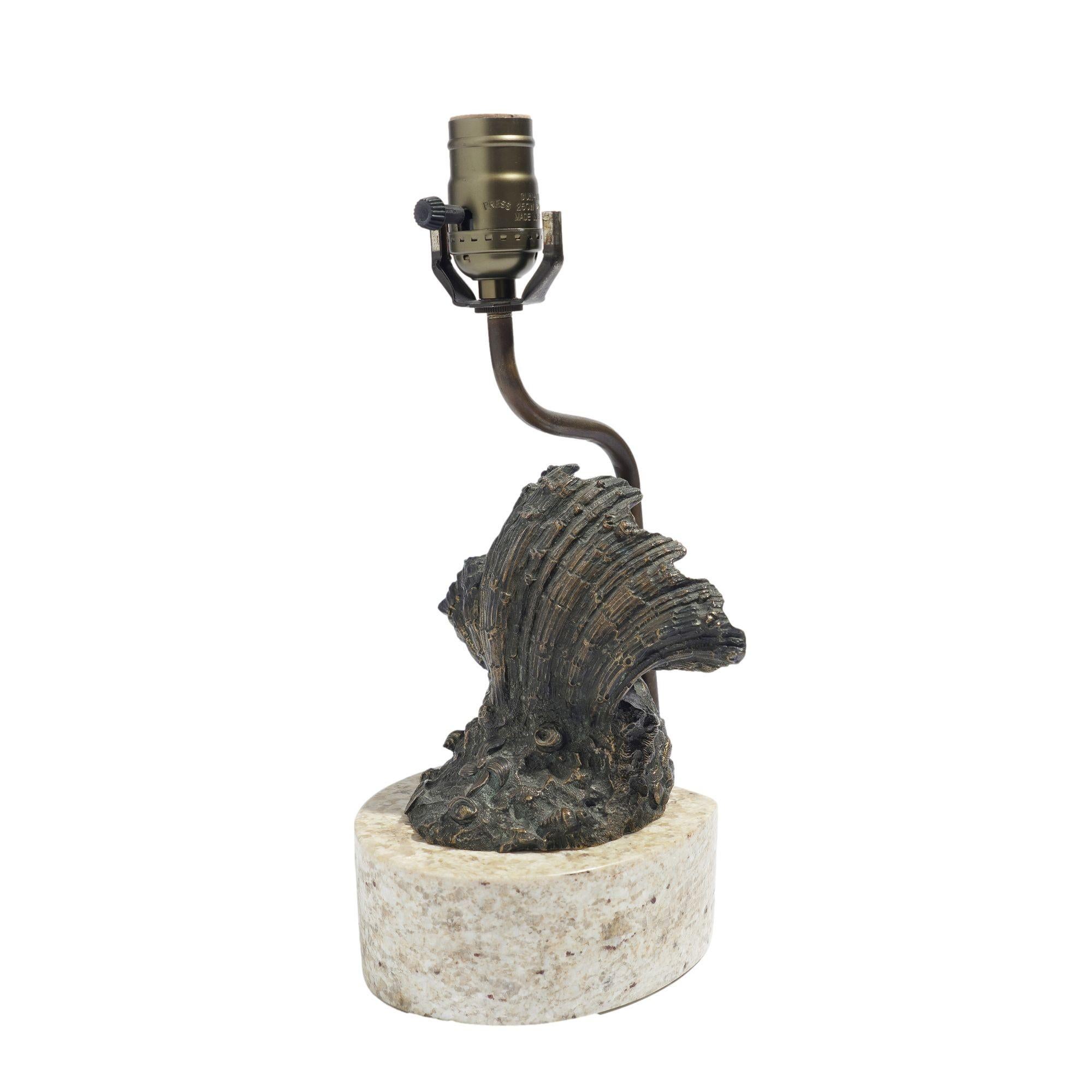 Cast bronze shell shaped dish mounted on a custom marble base and wired for use as a lamp. The top of the conduit accommodates a full sized bulb, and a miniature bulb socket is positioned behind the shell for additional illumination.
Continental,
