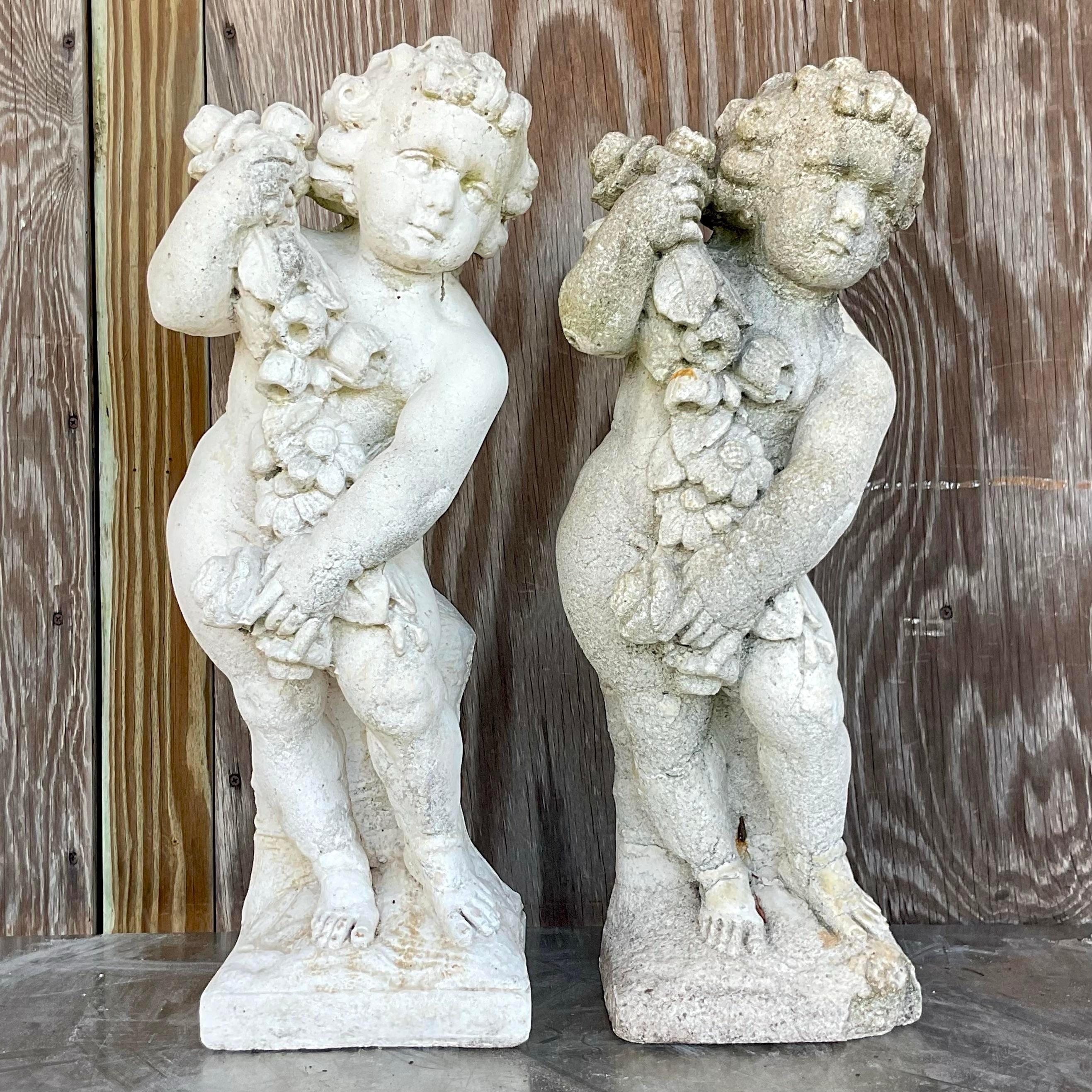 Vintage Boho Cast Concrete Season Statues - A Pair infuse your space with quintessential American style. These captivating statues, with their weathered patina and bohemian allure, evoke a sense of nostalgia while adding a touch of artistic flair to