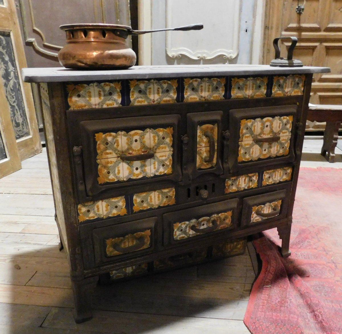 Vintage cast iron and Majolica stove, functional and complete with ash drawer, flap doors to insert wood and food to be cooked, produced in the early 1900s, from southern Italy (Sicily), beautiful yellow, blue and white colored Majolica.
Measures: