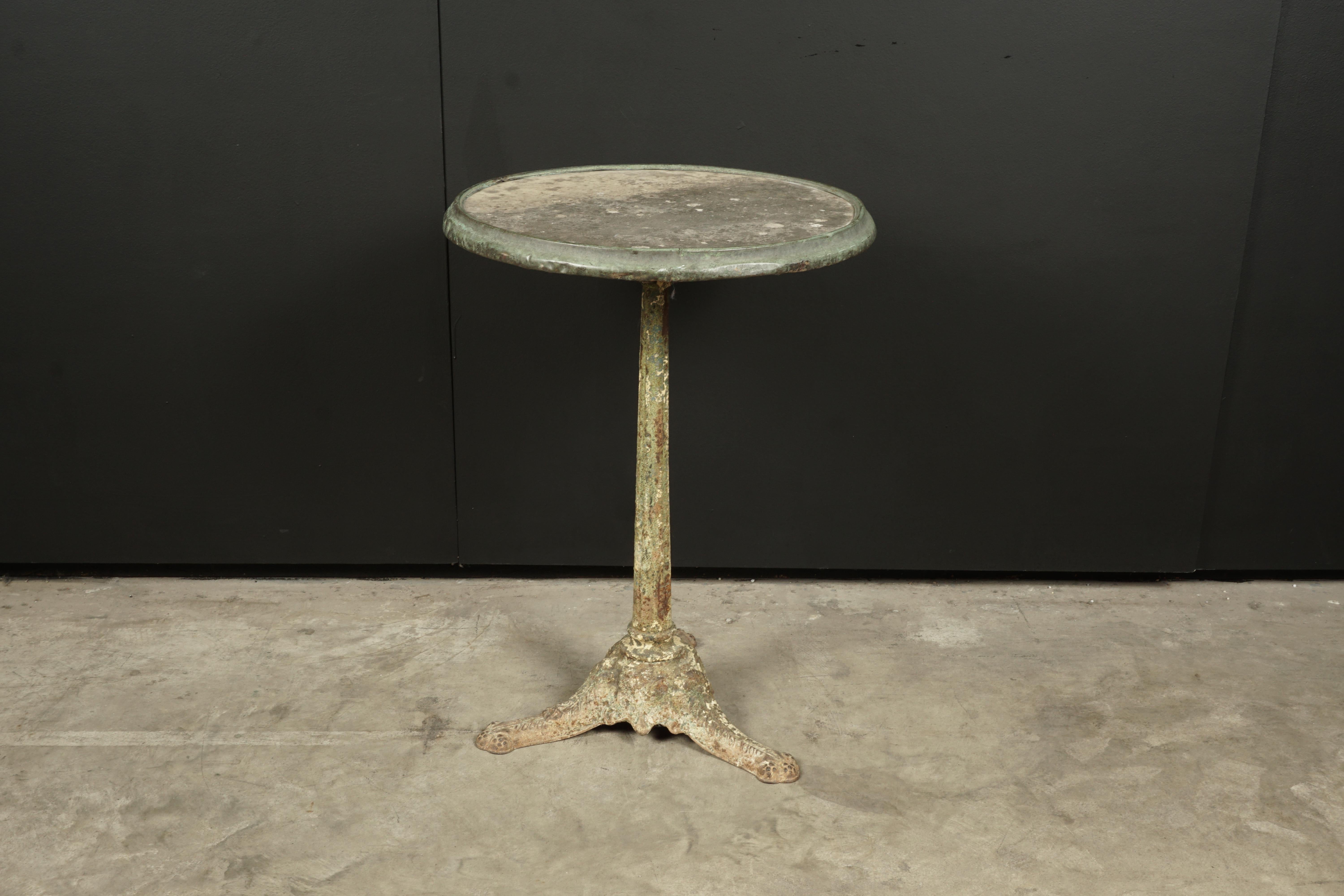 Vintage cast iron bistro table from France, 1930s. Cast iron base with concrete top and copper edge. Fantastic wear and patina.