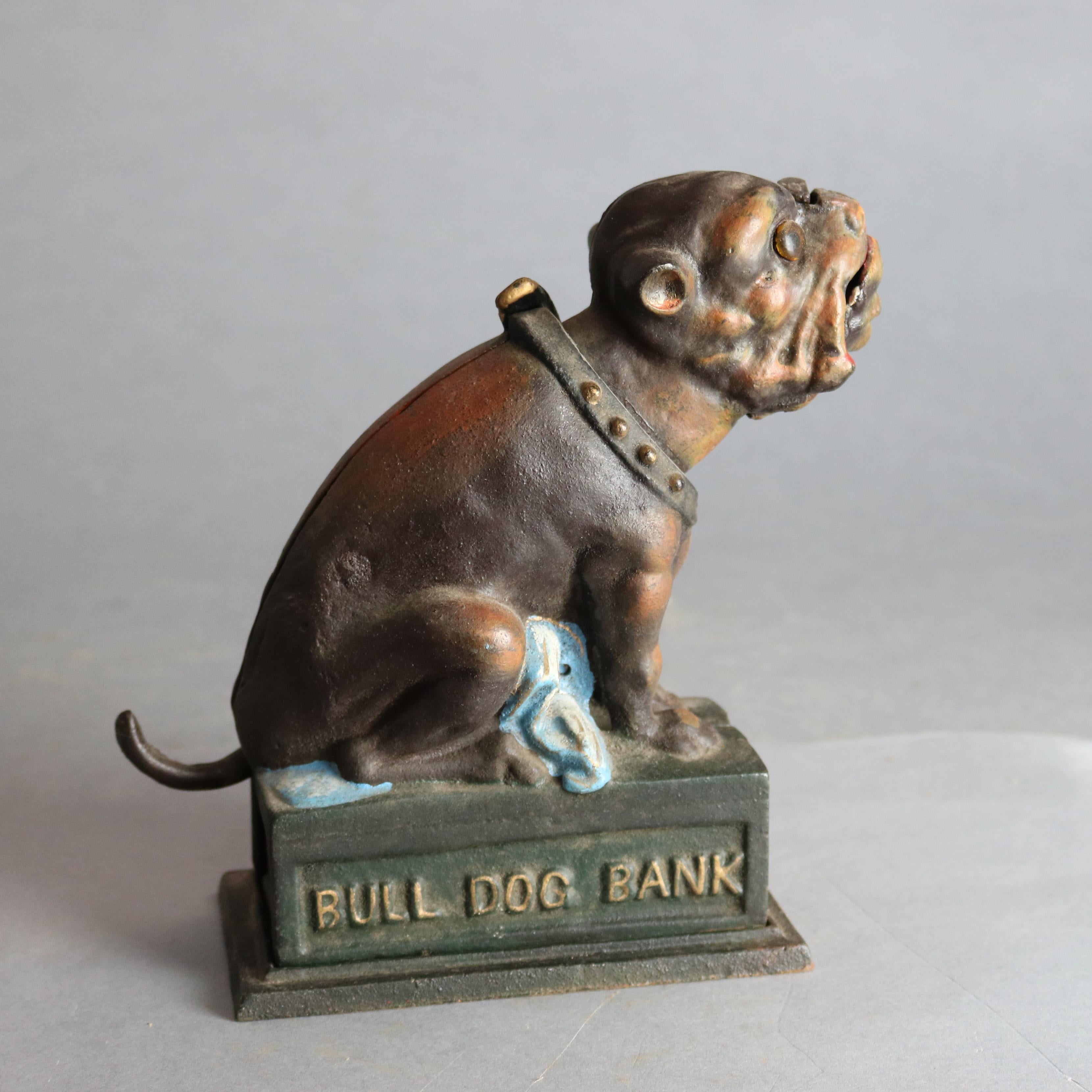 A vintage book of knowledge bull dog mechanical bank offers polychrome painted cast iron construction with bulldog having studded collar, embossed on base 