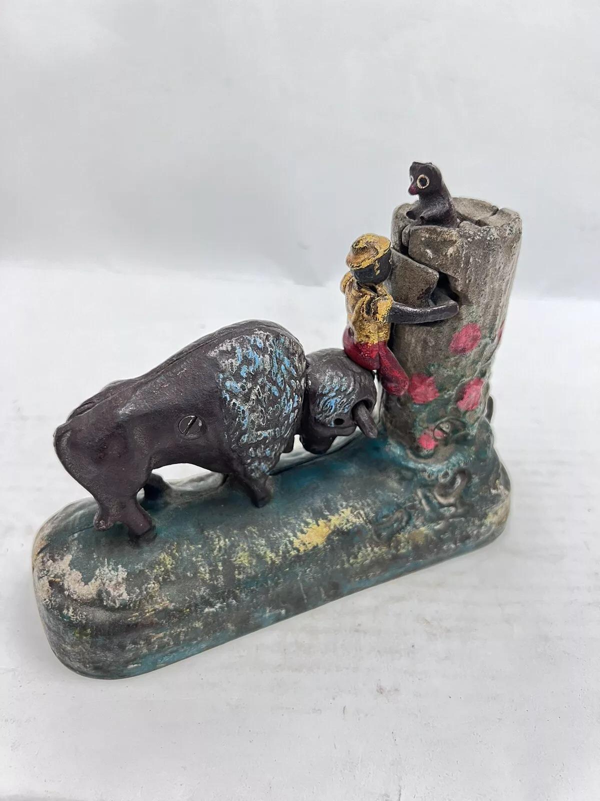 Vintage Cast Iron Book Of Knowledge Butting Buffalo Coin Piggy Bank. Circa Late 20th Century. Measurements: 6