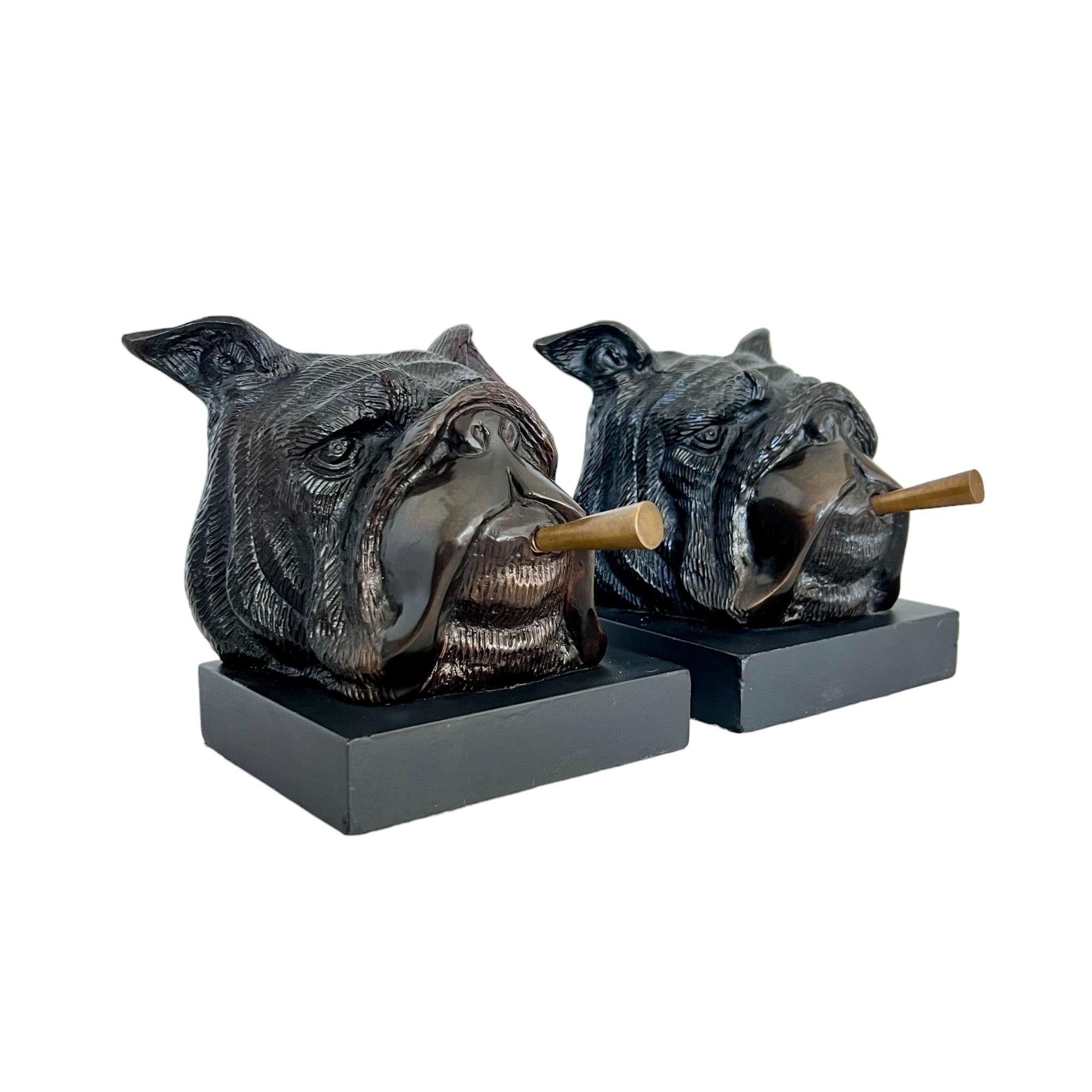 A pair of vintage 1940's smoking English bulldog bookends. Heavy cast iron heads with brass cigars on wooden bases. 

Dimensions: 5.5