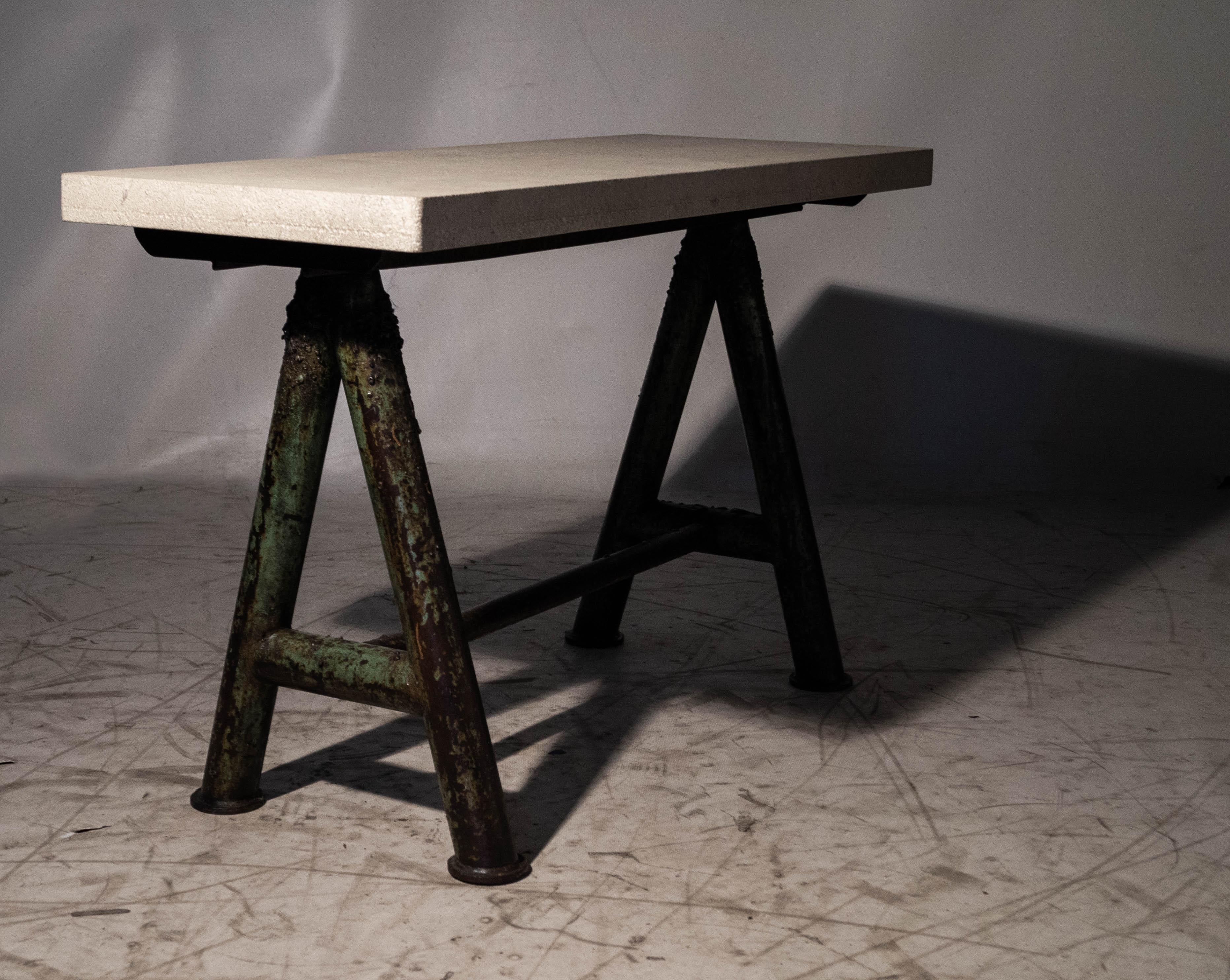 Vintage Cast Iron Craftsman's sawhorse with heavily weathered limestone top console. 

Exclusive to Brendan Bass.