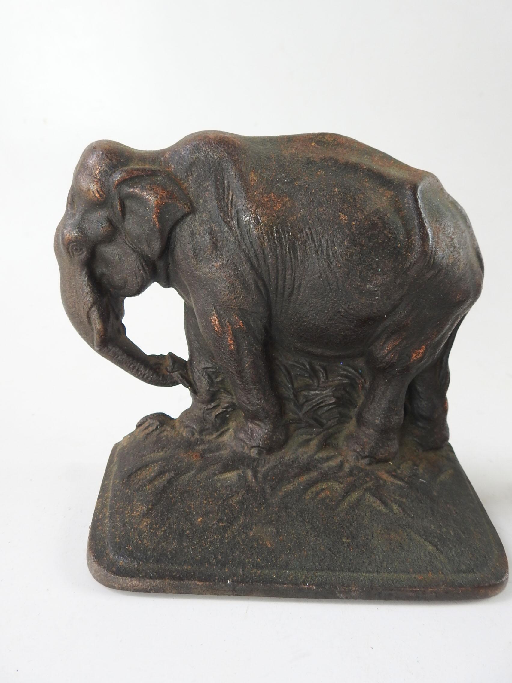 Vintage cast iron elephant bookends. Unmarked, little bit of original copper finish remains, wear to finish, scuffing, felt bottoms missing.