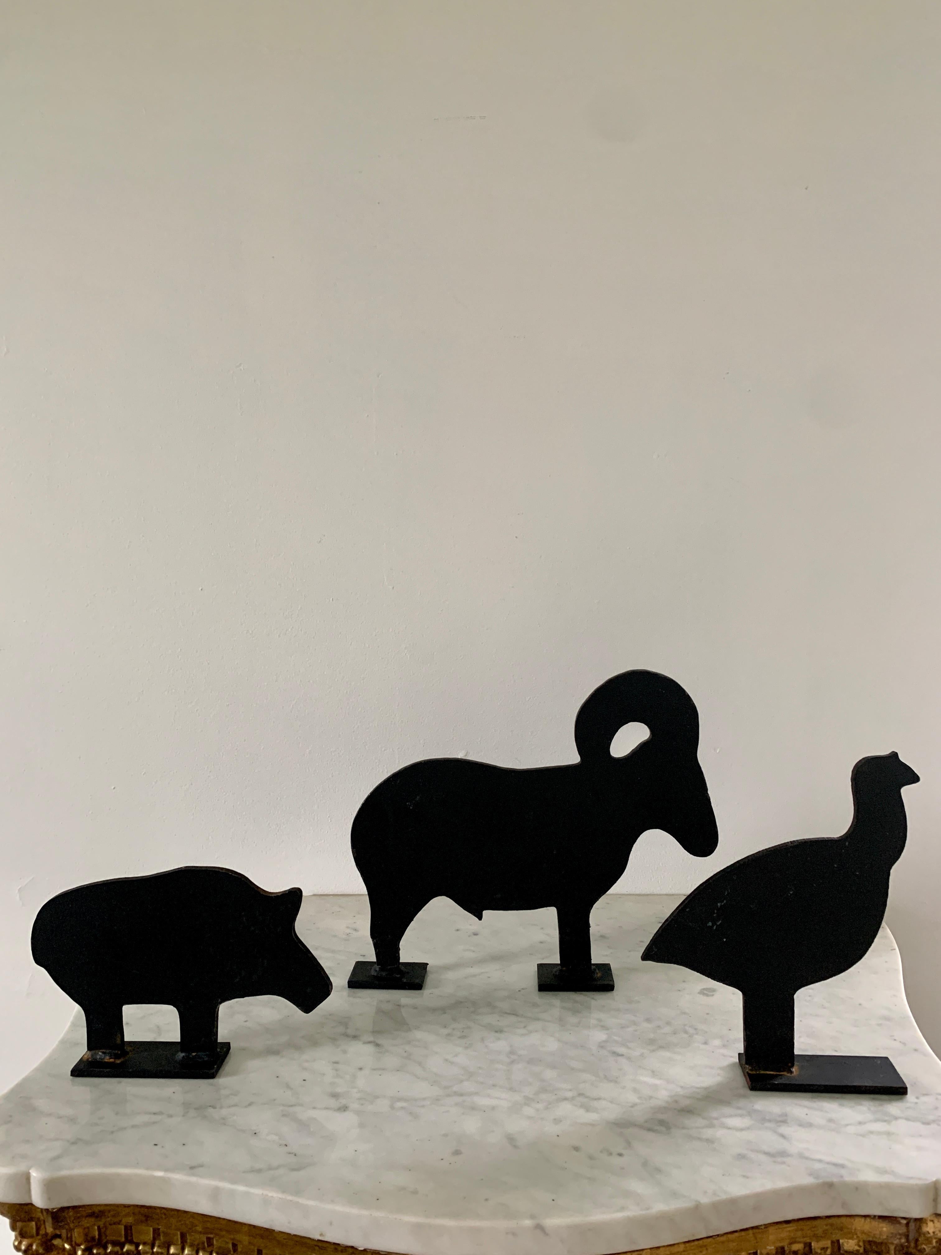 A charming set of three farmhouse country cast iron door stops or garden art in the form of a ram, pig, and quail. 

USA, Early 20th Century

Ram measuers: 12