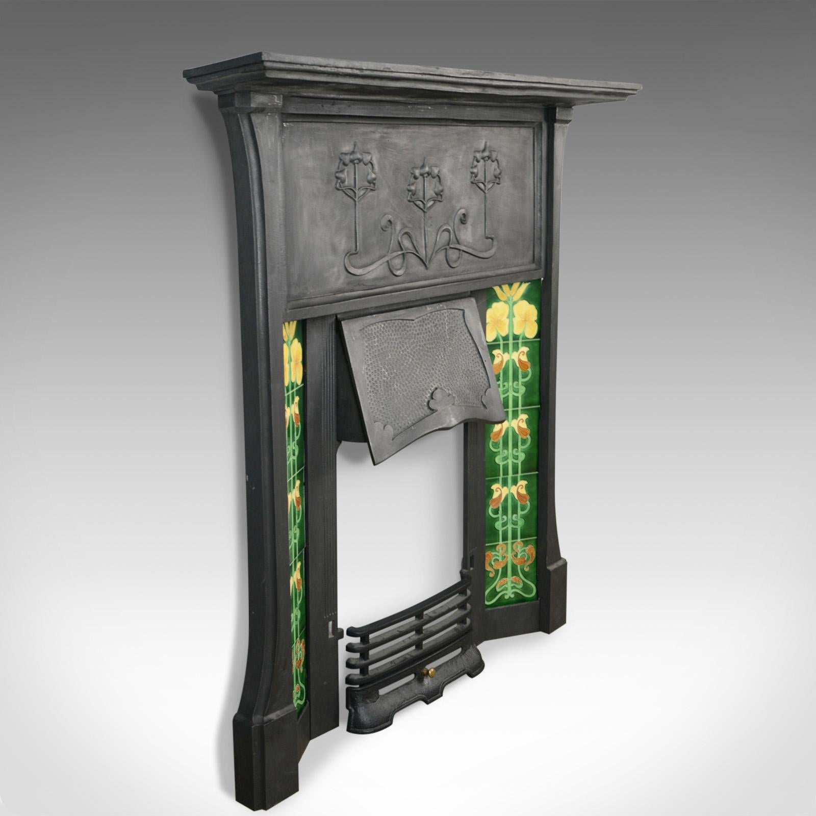 This is a vintage cast iron fire surround in the Art Nouveau taste. A late 20th century mantel piece with ceramic tile flanks.

In good proportion with a graphite finish
In quality cast iron with fine detail
Mantel over broad, classically