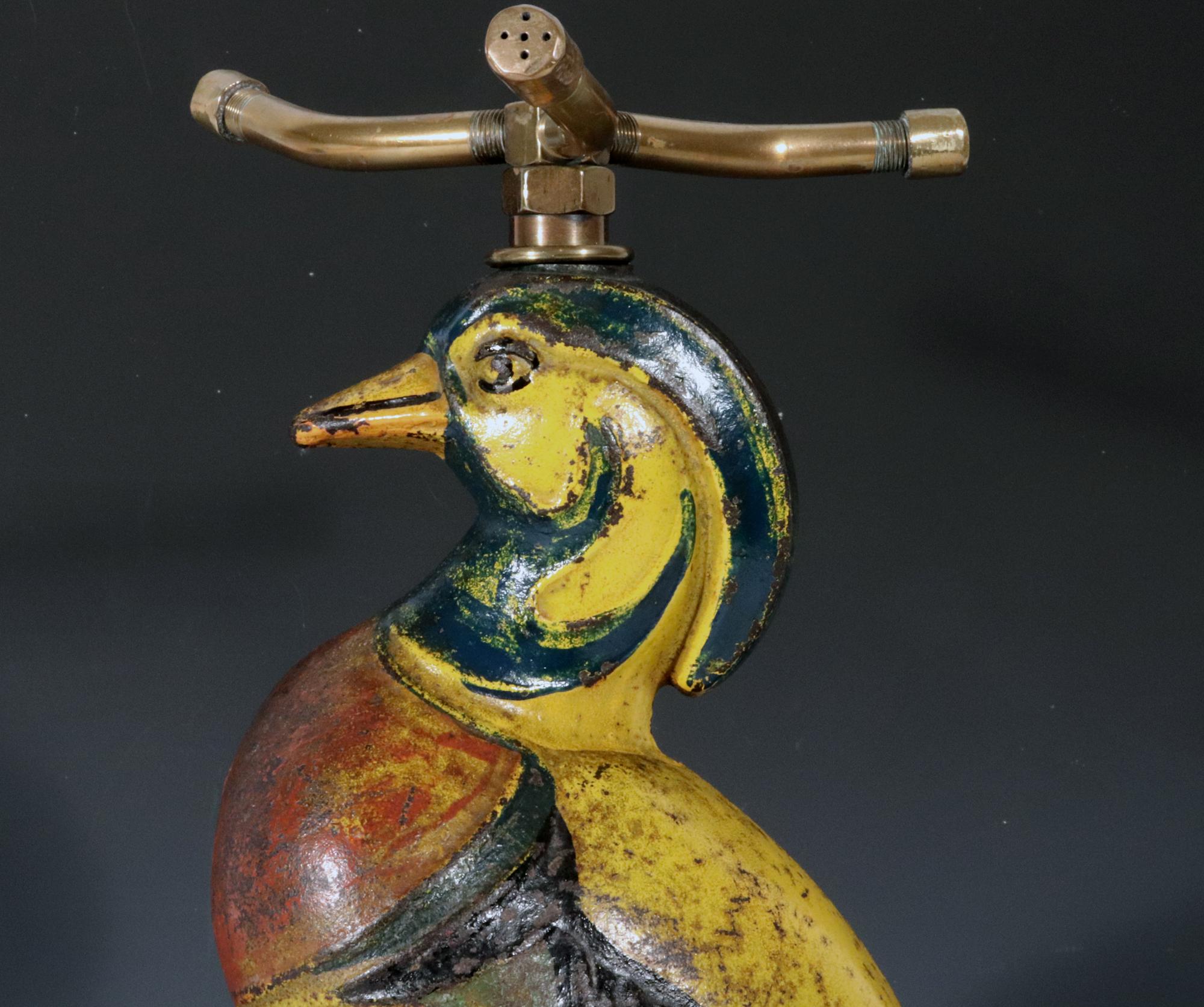 Vintage Cast Iron Lawn Sprinkler,
Sitting Wood Duck,
Nuydea Foundry,
1920s-1930s

The cast iron early lawn sprinkler is in the form of a wood duck sitting on an upturned clam shell with original brass fittings- intake and three arm sprinkler