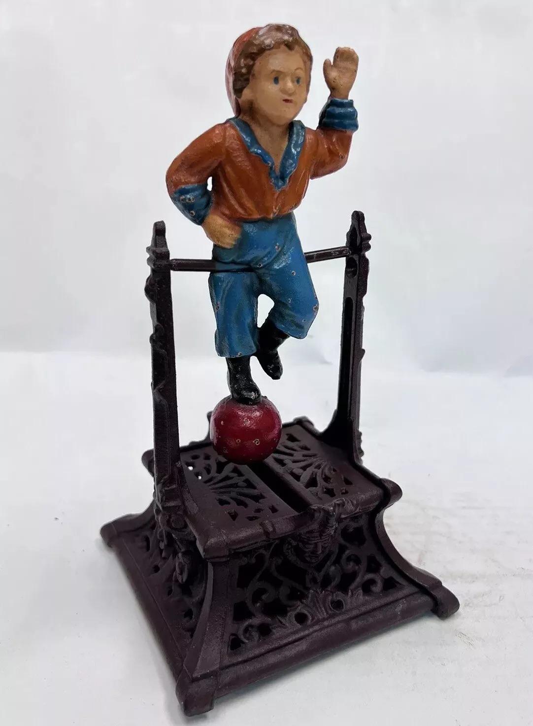 Vintage Cast Iron Still Bank Boy On Trapeze Book Of Knowledge Mechanical Bank. Underside reads 