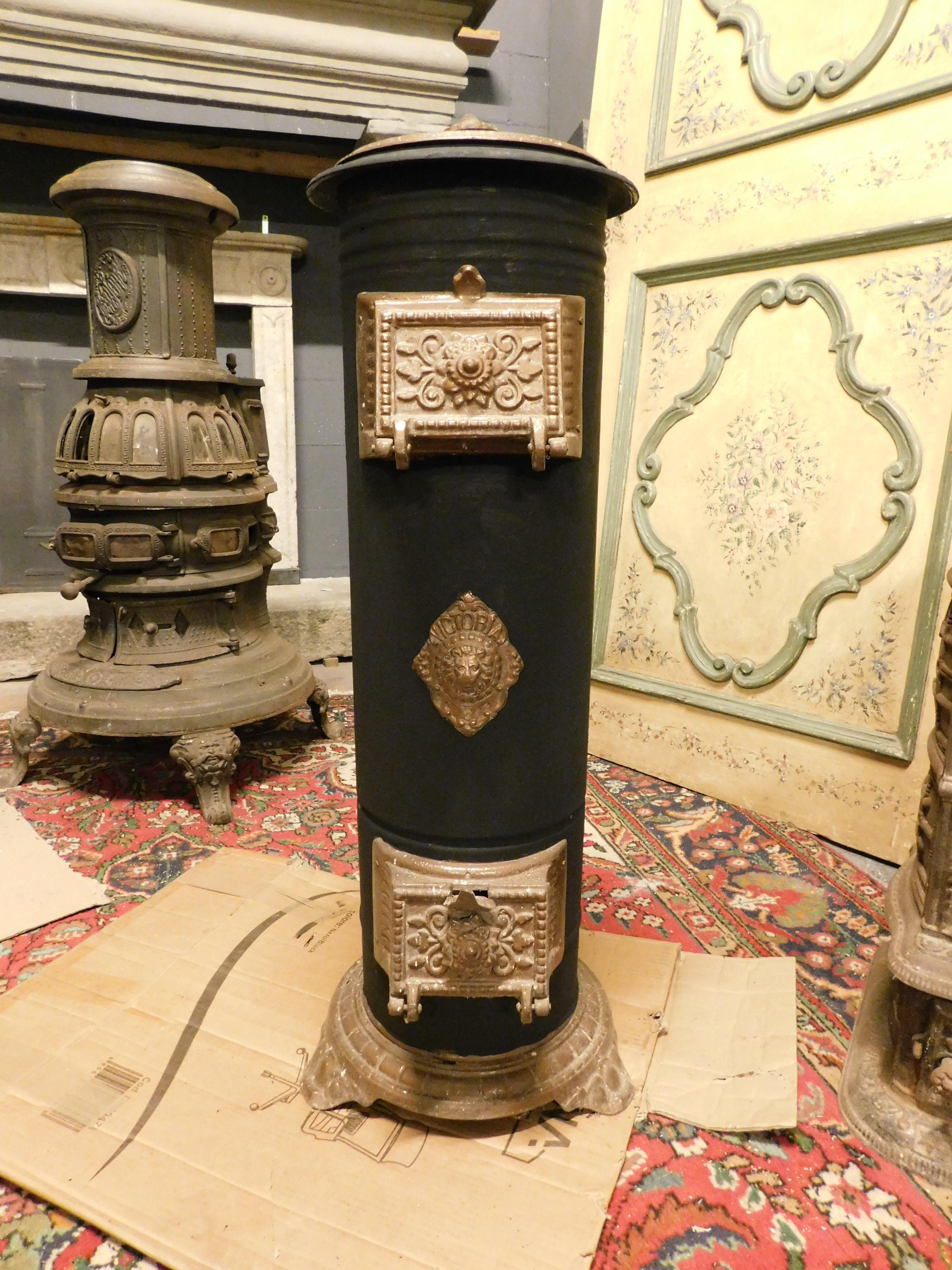 Vintage cast iron wood stove, black and gold enamelled with original perforated door and gold decorations, produced in Italy from the 1900s, measuring cm W 35 x H 95 x D 30