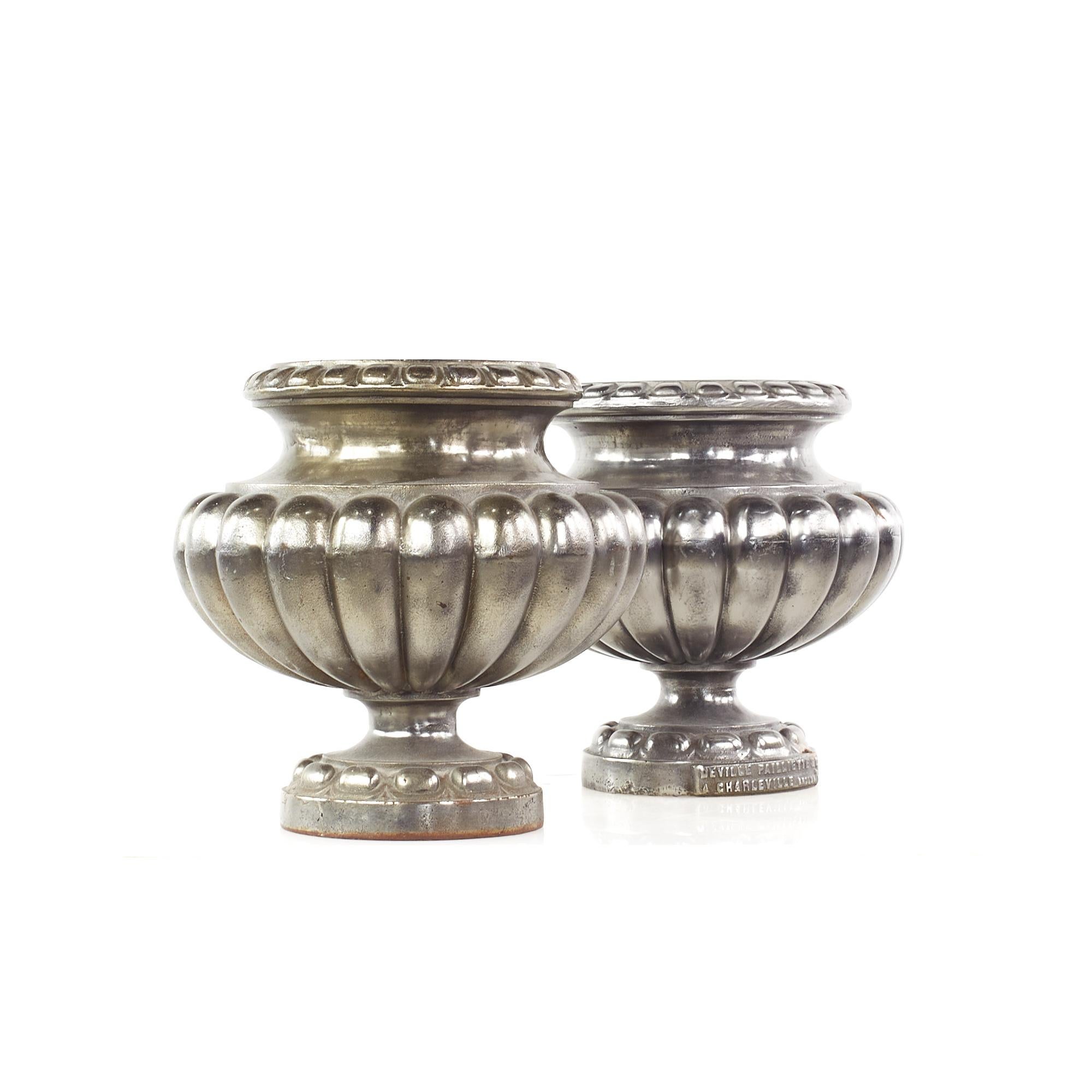 Vintage cast iron urn pots - pair.

Each urn measures: 11 wide x 11 deep x 11.5 inches high.

This set is in great Vintage condition with some rust spots in places.

We take our photos in a controlled lighting studio to show as much detail as
