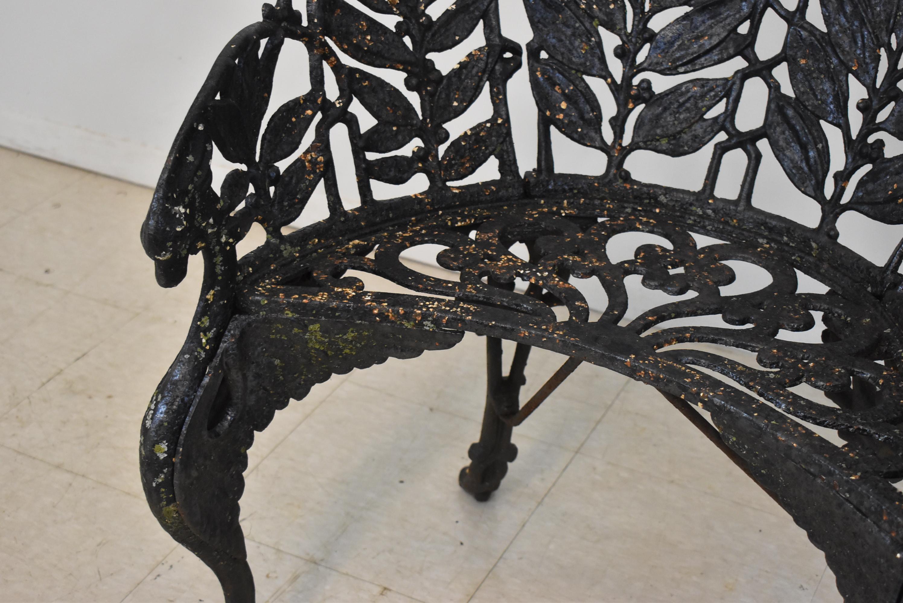 Vintage turn of the century cast iron winged dragon griffin garden bench. Two front side support figural winged dragons with leaf pattern back. Old paint. Very good condition. Dimensions: 23