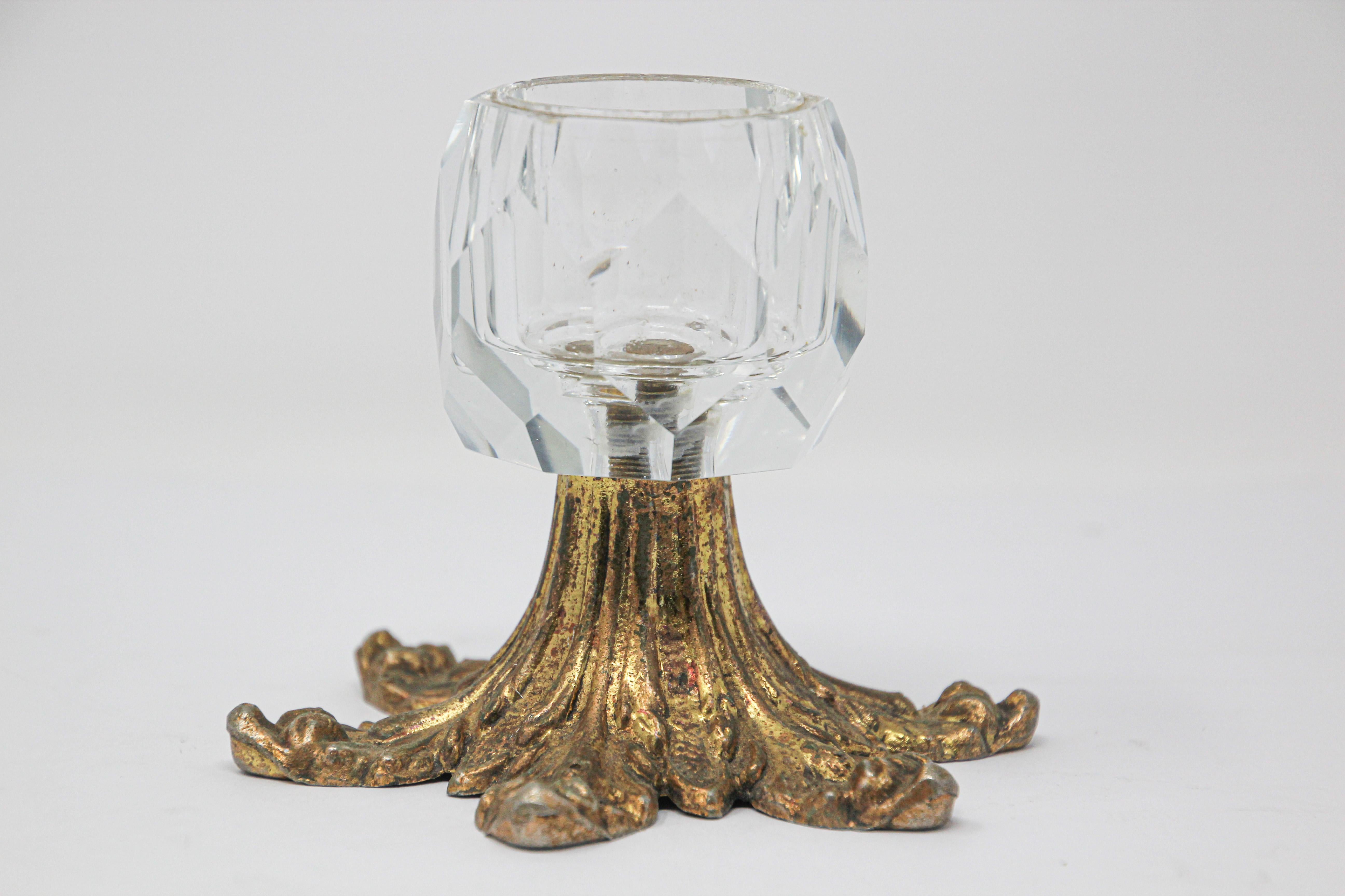 Vintage midcentury cast metal brass and glass candlestick.
The brass stand featuring leaves design.