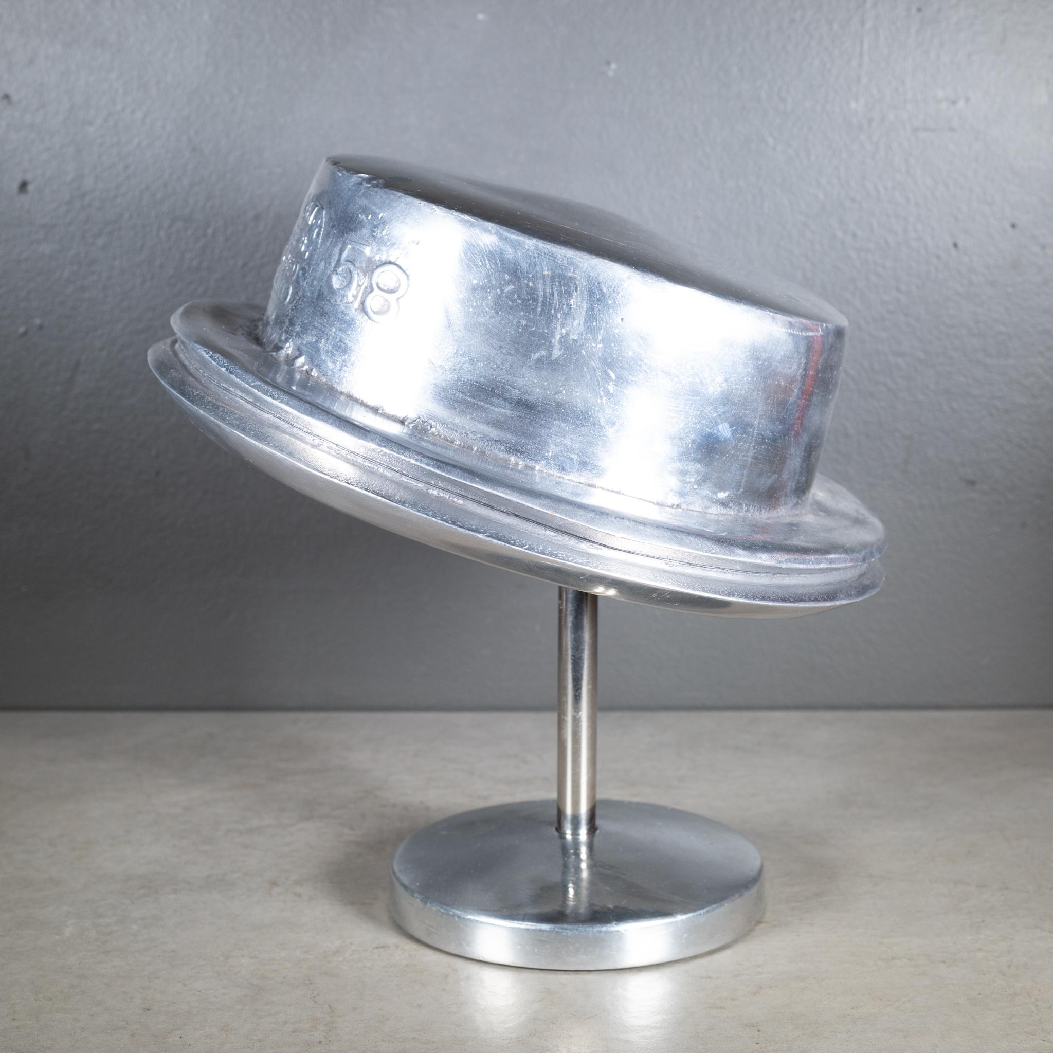 ABOUT

An original cast steel and nickel milliner pork pie hat form embossed with the company's name and address and numbers on both sides. Used as a store display at the milliner's factory. Attached adjustable display stand.

Substantial in