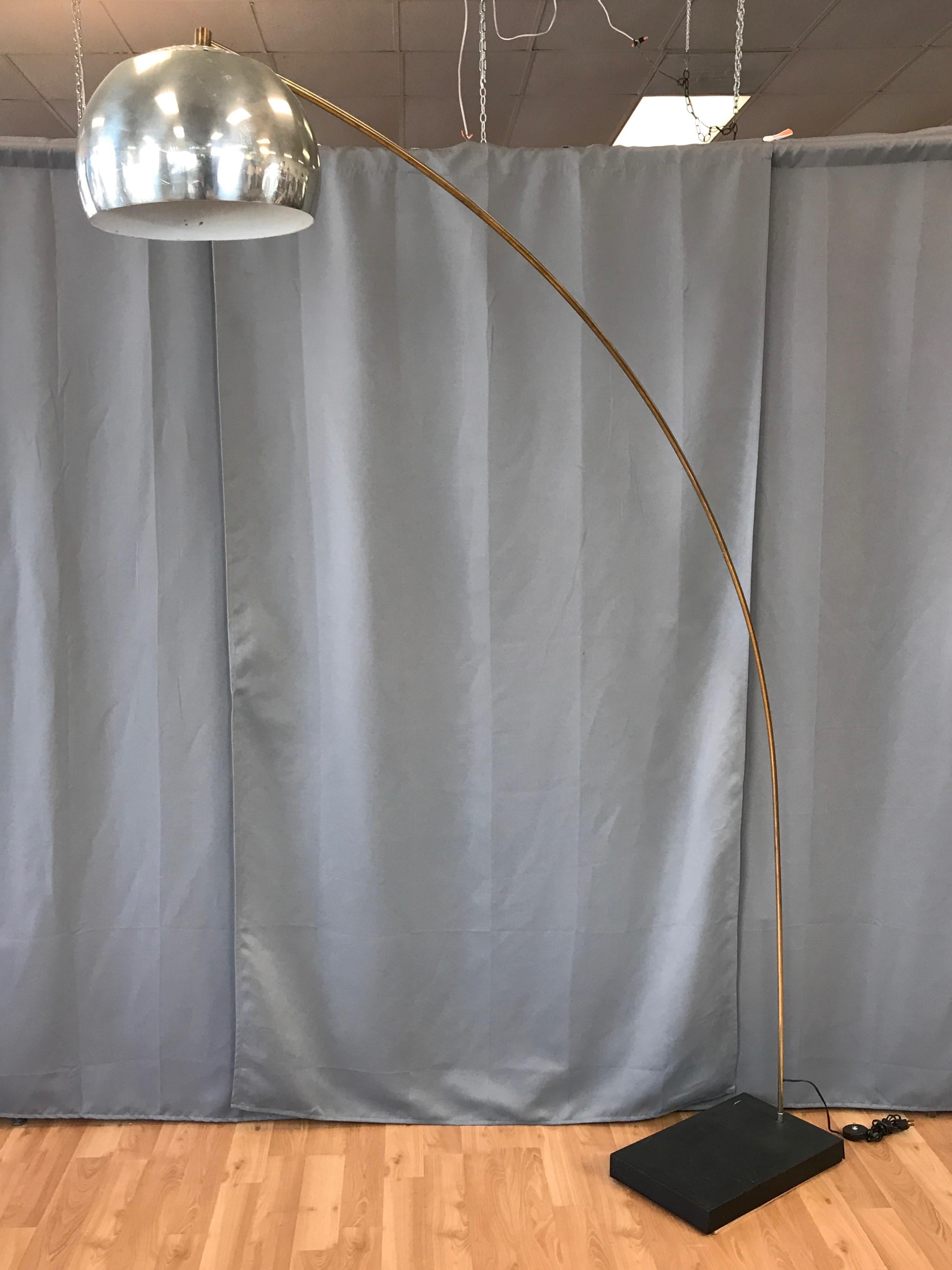 An impressively large vintage brass and chrome positionable arc floor lamp in the style of Achille Castiglioni and Robert Sonneman.

Rare two-tone example of an uncommon design, with stem, fittings, and diffuser in brass-colored finish, and shade