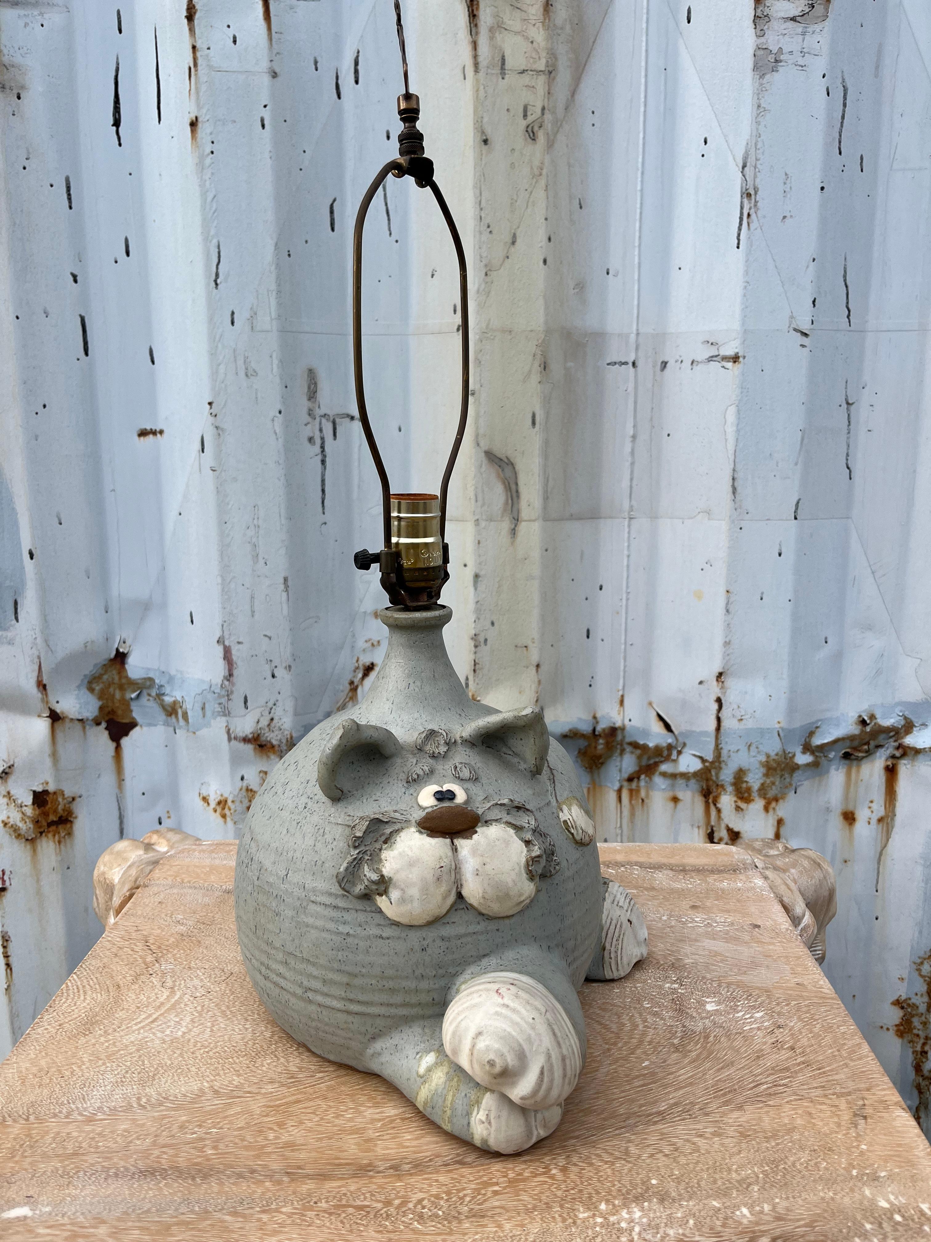 Vintage Cat Ceramic Table Lamp by Fogarty Ceramic Studio. Circa 1970s 
Features a whimsical handcrafted gray cat base with a brass cat finial. Signed by the Fogarty Ceramic Studio. 
In excellent Original Condition with very minor signs of wear and