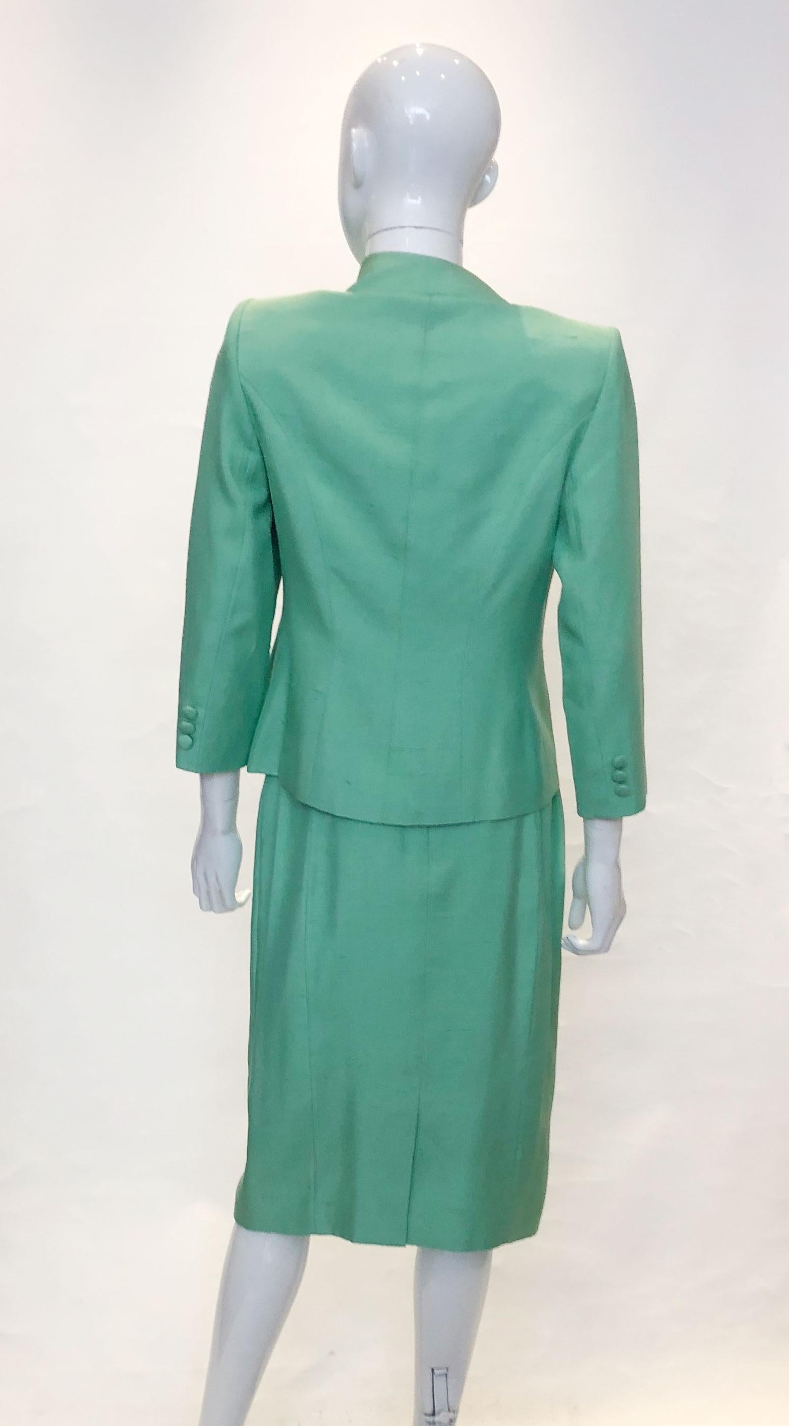 A vintage Catherine Walker skirt suit in emerald green silk. 
Measurements : Jacket bust 38'', length 21'', skirt waist 28'' , length 27''