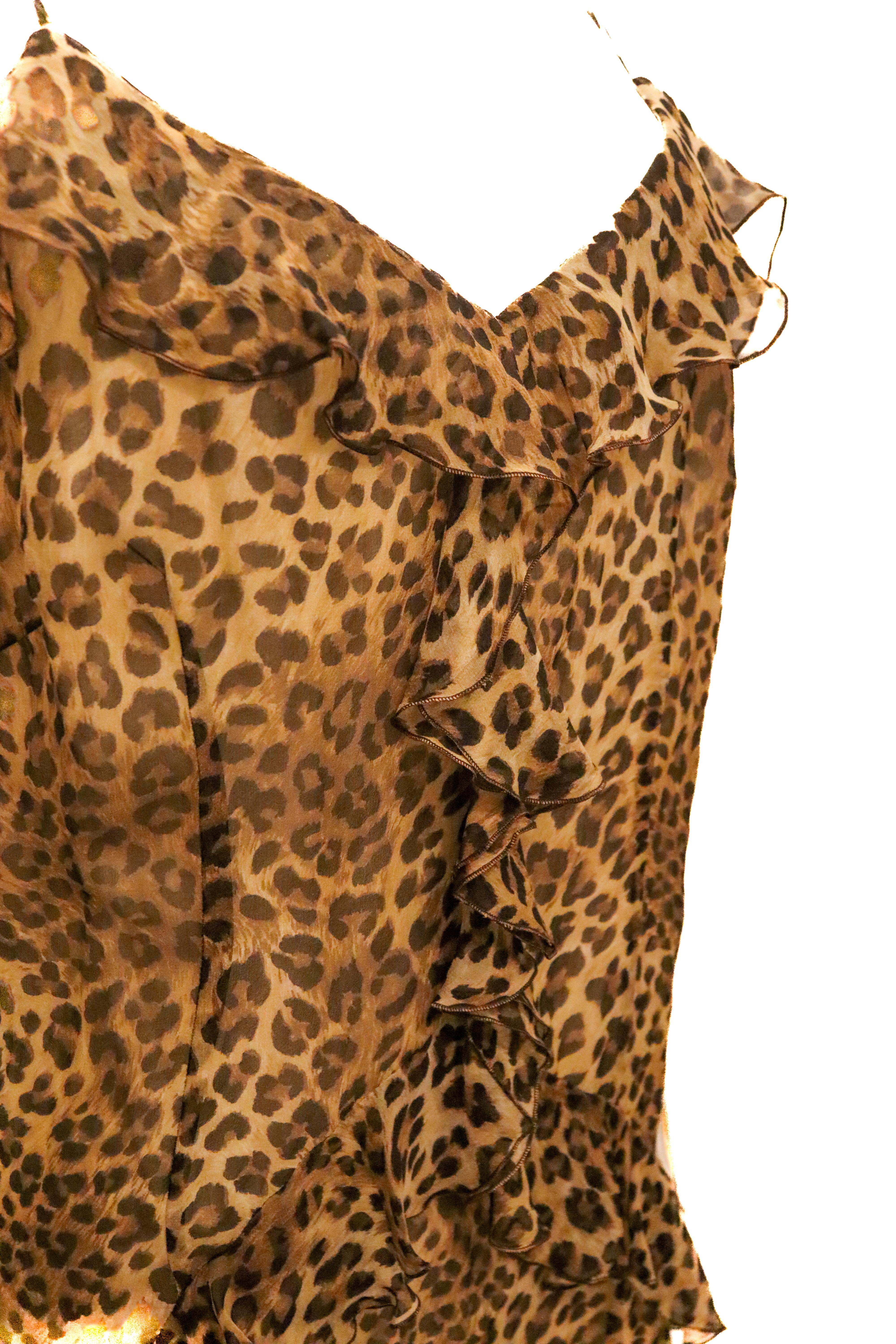 A fun vintage frock by Catherine s Couture. The  dress is in a leopard print silk with ruffles on the front and centre. It is fully lined with a zip opening and spaghetti straps that cross over at the back. 
Made in Italy, Italian size 48.
