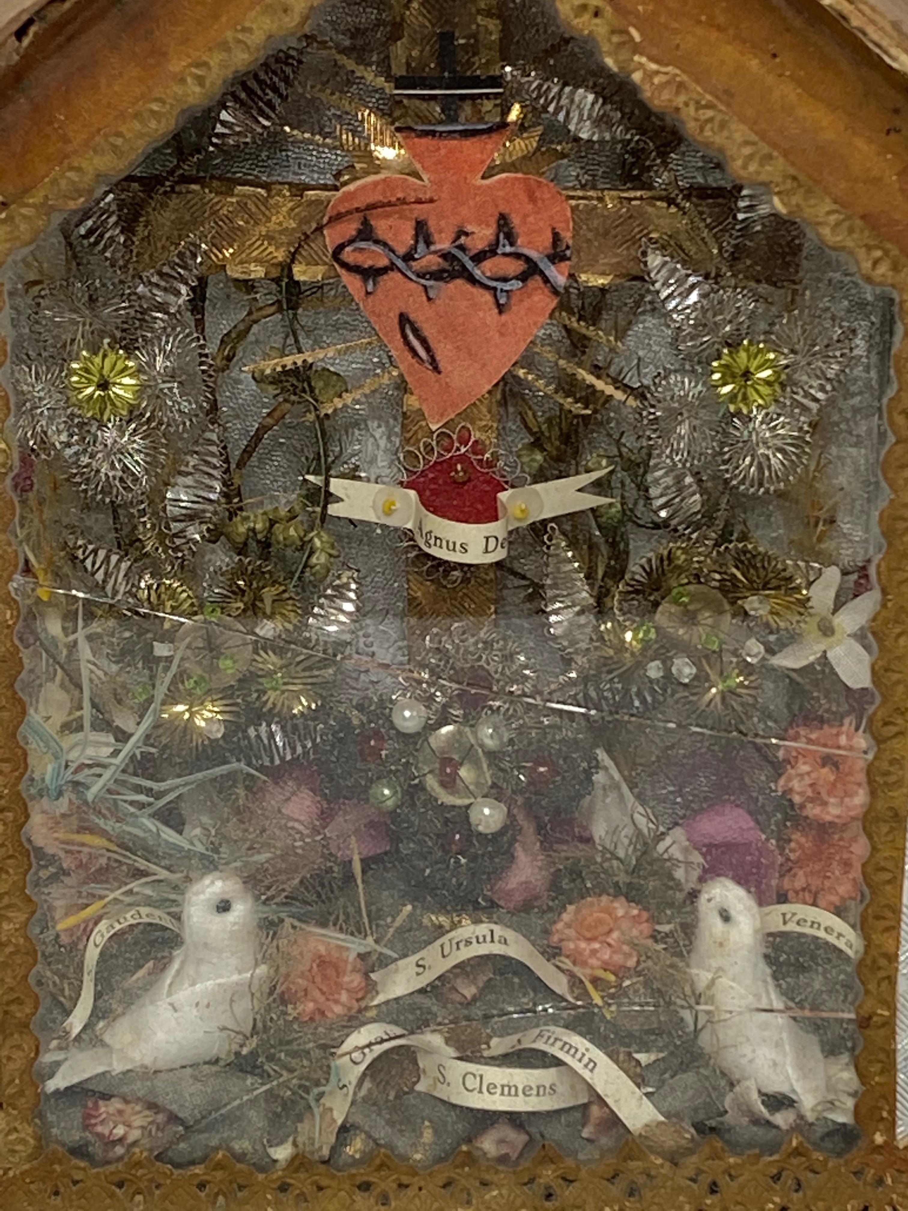 This antique reliquary showcase contains relics of Saint. It is made of cloth, glass, tinsel, wood and cardboard. Its a monastery work mostly made by nuns. It was found at an estate sale in Vienna, Austria. Some cracks in the glass but this is