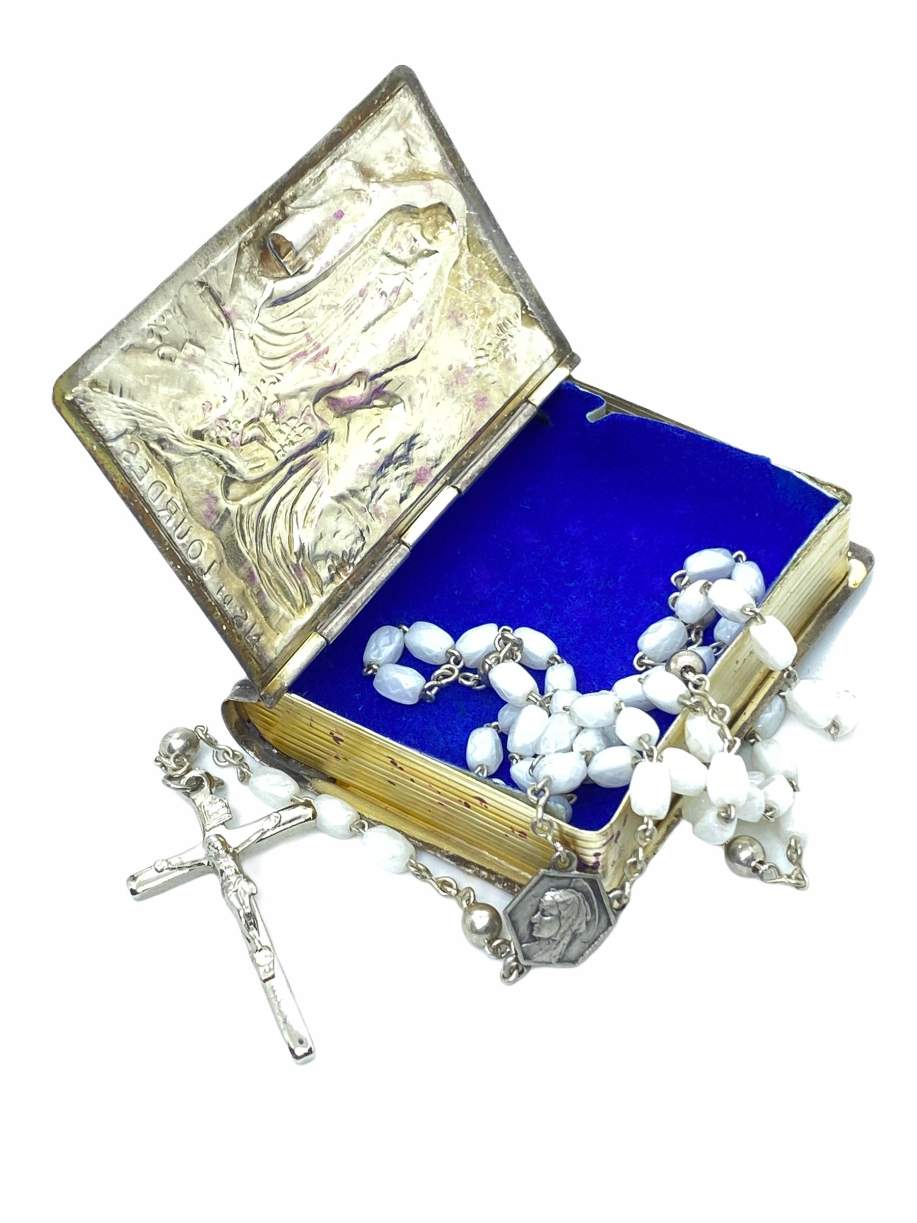 This vintage silver tin box was a souvenir from a pilgrims journey to the famous City of Lourdes in France. It is made of silver Tin and contains a Rosary. The Rosary is approx. 15 inches in length, that making it easily worn.

   