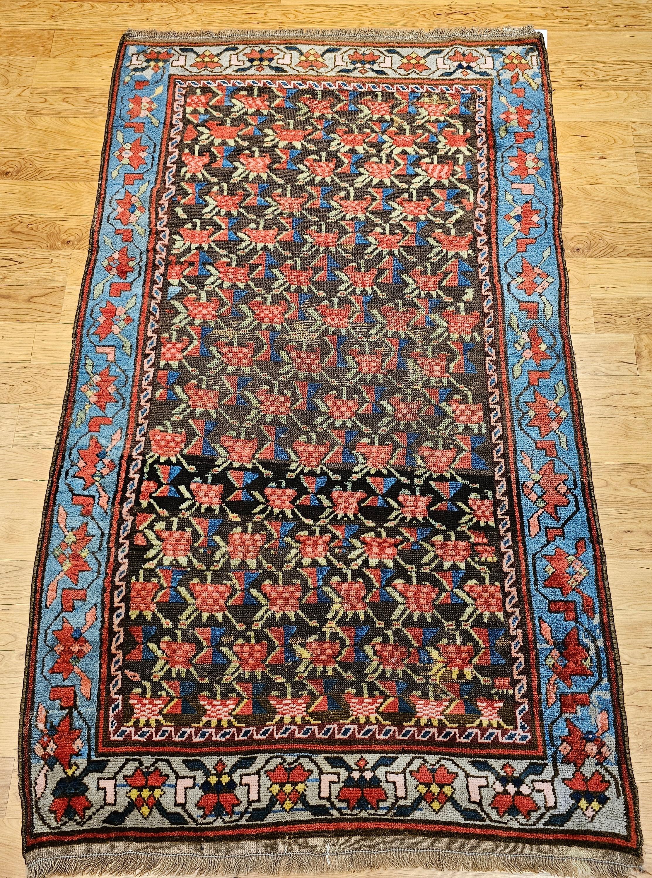 Vintage Karabagh area rug from the Armenian village weavers of the Caucasus mountains has a wonderful allover pattern in brown, royal blue, red, green, and yellow. It has a wonderful abrash brown/black field color which sets up beautifully the